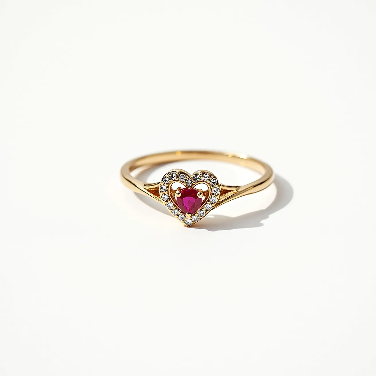 This heart promise ring features a delicate gold band with a central heart-shaped motif. At the core of the heart lies a vibrant red gemstone, possibly a ruby, cut with precision to enhance its color and brilliance. Surrounding the central stone is a halo of small, sparkling diamonds, each carefully set to accentuate the centerpiece. The setting ensures both security and prominent display of the stones, highlighting the craftsmanship of the piece. The overall design is elegant and refined, exuding a sense of romance and commitment.