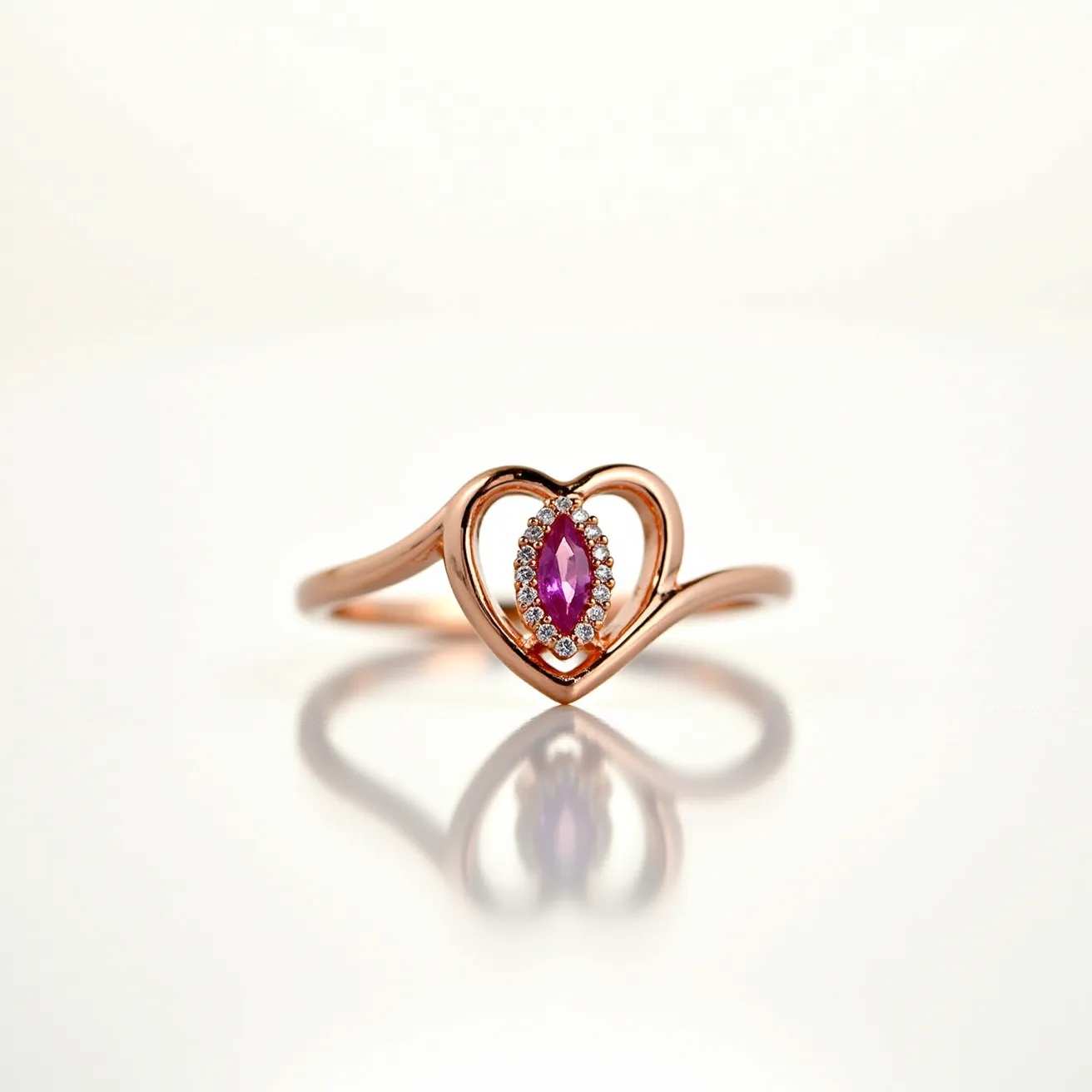 This heart ring features a delicate rose gold band that forms an open heart shape at the center. Nestled within the heart is a marquise-cut pink gemstone, which is likely a sapphire or similar stone, adding vibrant color and elegance. Surrounding the centerpiece are small, round-cut white stones, likely diamonds, set in a halo style to enhance the central gem's brilliance. The ring's smooth, polished metal and precise stone setting reflect a refined craftsmanship, making it a striking piece of jewelry.