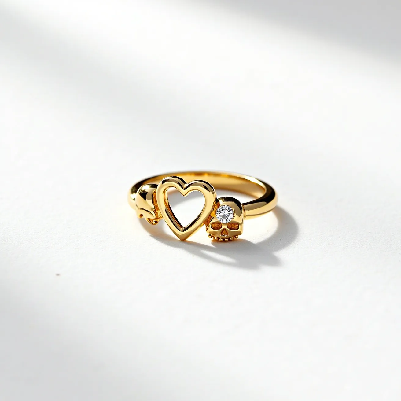 This heart ring features a delicate open-heart design crafted from a radiant gold material, suggesting a luxurious appeal. Adjacent to the heart sits a small, polished skull motif, which holds a sparkling round-cut gemstone that is likely a diamond or cubic zirconia, securely set into the skull's eye. This unique detail adds both contrast and charm to the overall aesthetic. The ring's band is smooth and crafted from the same gold material, providing a consistent and elegant appearance. The design emphasizes a blend of elegance and edgy sophistication, making it a distinctive piece of jewelry.