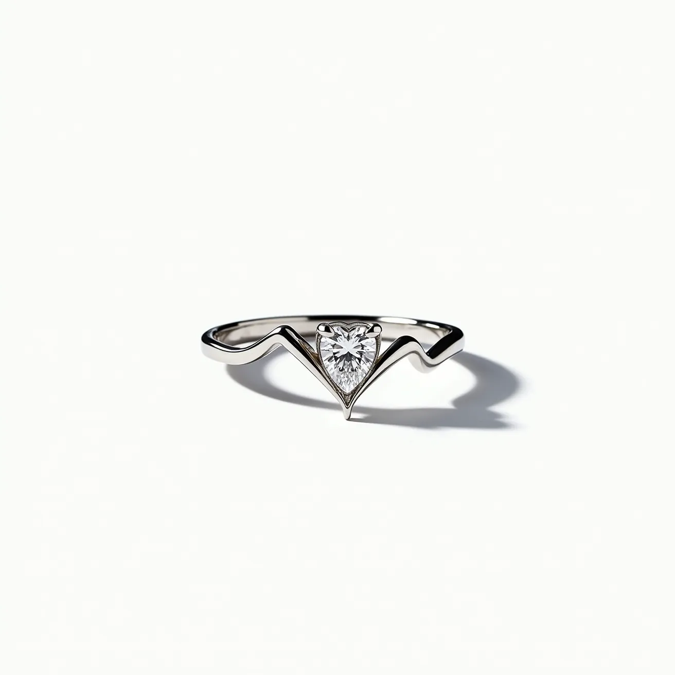 This heart wedding ring features a sleek and modern design crafted from lustrous white gold or platinum, forming a smooth, polished band. At its center, a sparkling heart-shaped diamond is expertly cut and set within a secure prong setting, enhancing its brilliance and allowing maximum light reflection. The elegant contours of the band complement the gem, providing a harmonious balance between the metal and the stone, while maintaining a comfortable fit for the wearer.