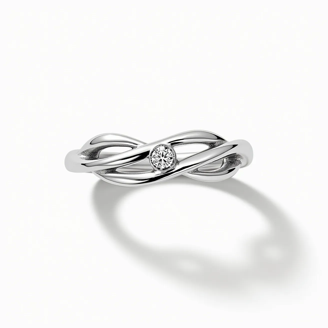 This infinity ring features a sleek and polished metal band, likely made of white gold or platinum, intertwined in a graceful infinity symbol design. At its center, the ring showcases a single round brilliant-cut diamond, elegantly set in a bezel setting that adds to its modern aesthetic. The seamless design of the band emphasizes the continuous nature of the infinity symbol, offering both beauty and elegance without the need for clasps or attachments. The diamond's placement enhances the ring's symbolism of eternity and unity.