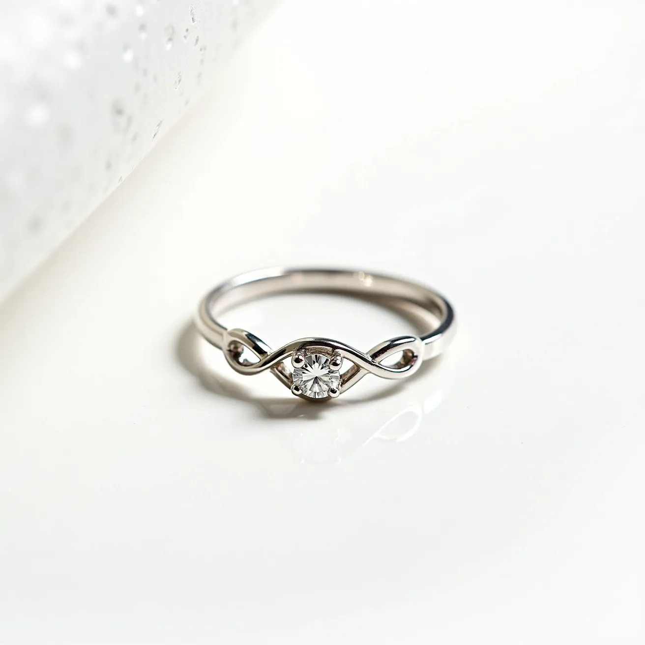 This Irish promise ring features a sleek, polished metal band, likely silver or white gold, showcasing a delicate and elegant design. At its center is a prominent, round-cut clear gemstone, possibly a diamond or a high-quality cubic zirconia, set securely within a four-prong setting. The gemstone is accentuated by an infinity symbol that curves gracefully on either side, adding a touch of symbolic meaning and intricate detailing to the overall design. There is no visible clasp or attachment, maintaining the smooth contour and classic allure of the ring.