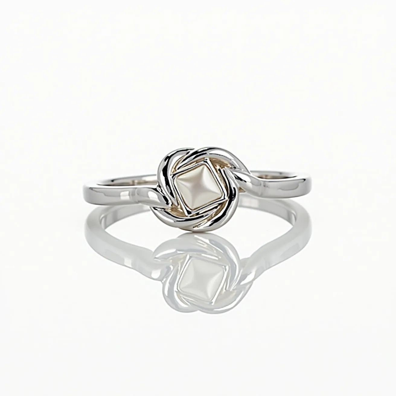 This knot ring features an elegant design crafted from a shiny metal, likely silver or white gold, which forms an intricate knot at the center. Nestled within the knot is a polished, spherical gem that appears to be a pearl, contributing a classic and sophisticated touch. The pearl is securely held in place by the intertwined loops of the metal, showcasing a seamless integration without additional attachments or prongs. This design ensures the focus remains on the harmonious blend of the intertwined metal and the central gem, creating a timeless piece of jewelry.