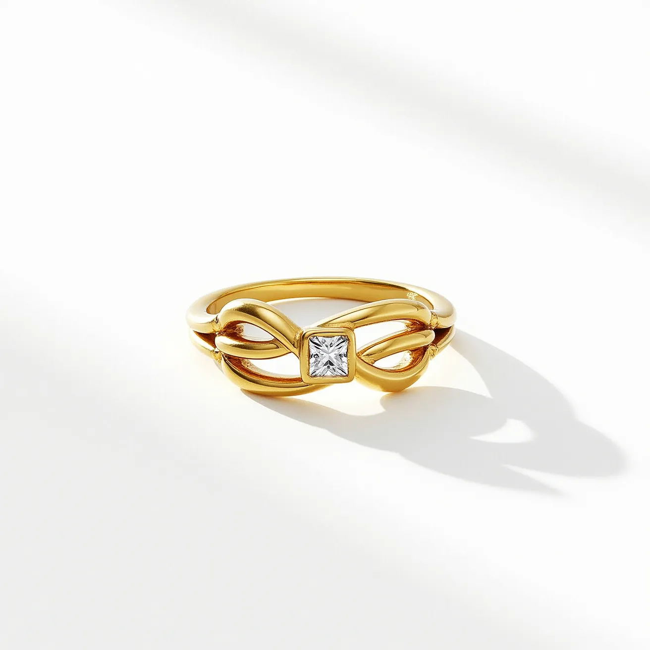 This knot ring is elegantly crafted with a gold band that forms a stylish and flowing knot design. At the center, a square-cut diamond is prominently set in a bezel setting, adding a touch of sophistication and sparkle to the piece. The diamond, clear and radiant, serves as the focal point amidst the warm tones of the gold material. The seamless design of the ring highlights the craftsmanship and elegance, making it a striking accessory.