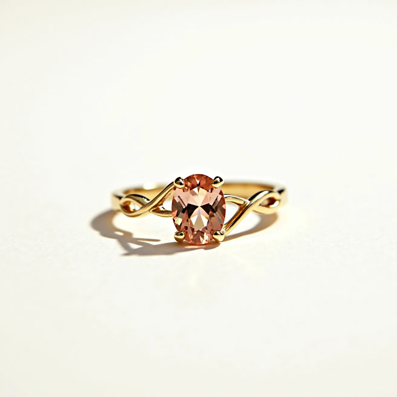 This love ring features a delicate and intertwined gold band that elegantly forms a twisted design. At its center, the ring showcases a sparkling oval-cut peach-colored gemstone, securely held in place by a four-prong setting. The interplay between the twisting band and the central stone creates a harmonious and romantic aesthetic, making it a symbol of enduring love and elegance.