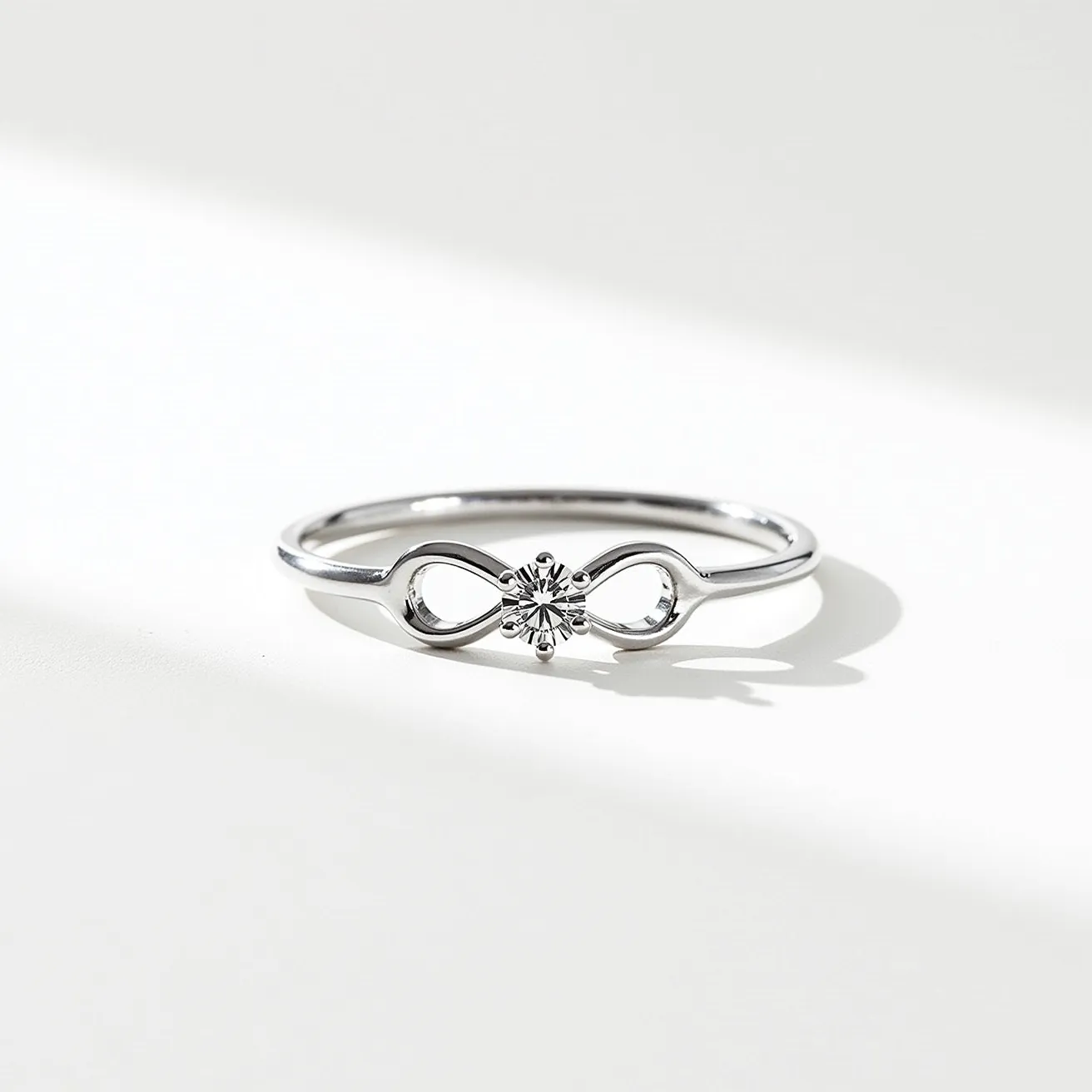 This love ring features a sleek metal band, likely crafted from silver or white gold, which elegantly forms an infinity symbol. Centrally positioned within this motif is a single, brilliant-cut diamond set in a secure 4-prong setting. The design is minimalist yet meaningful, highlighting the eternal nature of love symbolized by the infinity shape. The smooth, polished finish of the metal adds a sophisticated and timeless appeal to the overall design.