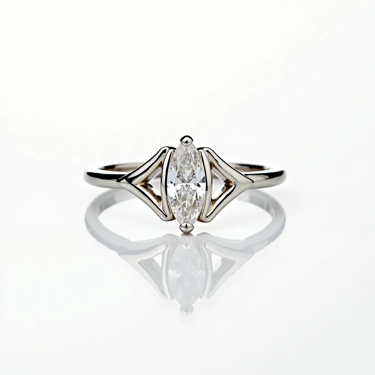 This marquise engagement ring features a central marquise-cut diamond set in a sleek metal band, likely crafted from white gold or platinum, given its lustrous appearance. The diamond, characterized by its elongated shape with pointed ends, is securely held in a distinctive setting that enhances its brilliance and prominence. The band is elegantly designed to highlight the center stone, incorporating artistic metalwork that frames the diamond with understated sophistication. The overall design presents a harmonious blend of classic elegance and modern artistry, making it a striking piece.