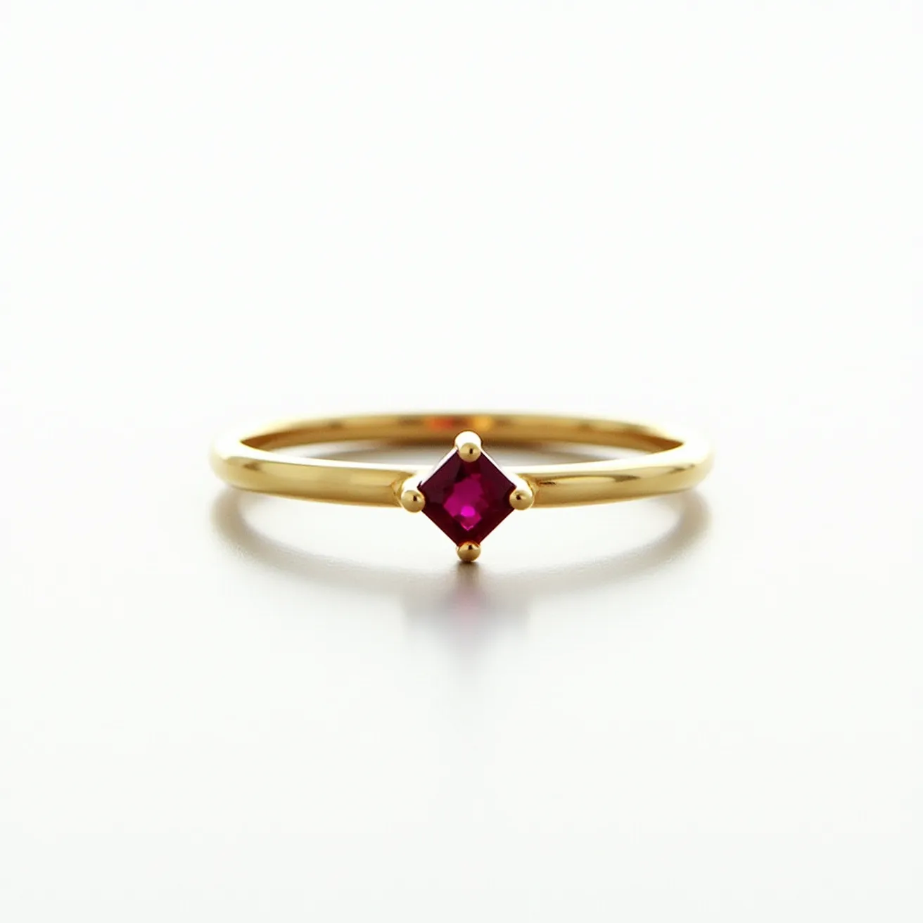 This men's engagement ring features a sleek, polished gold band that exudes sophistication and elegance. At its center, a vibrant red gemstone is prominently displayed in a princess cut, known for its square shape and brilliant facets that enhance its fiery color. The stone is securely held in place by a four-prong setting, allowing maximum light to pass through and enhance its brilliance. The simplicity of the design, with its minimalistic band and striking central gem, makes it a timeless piece that embodies both modernity and classic charm.