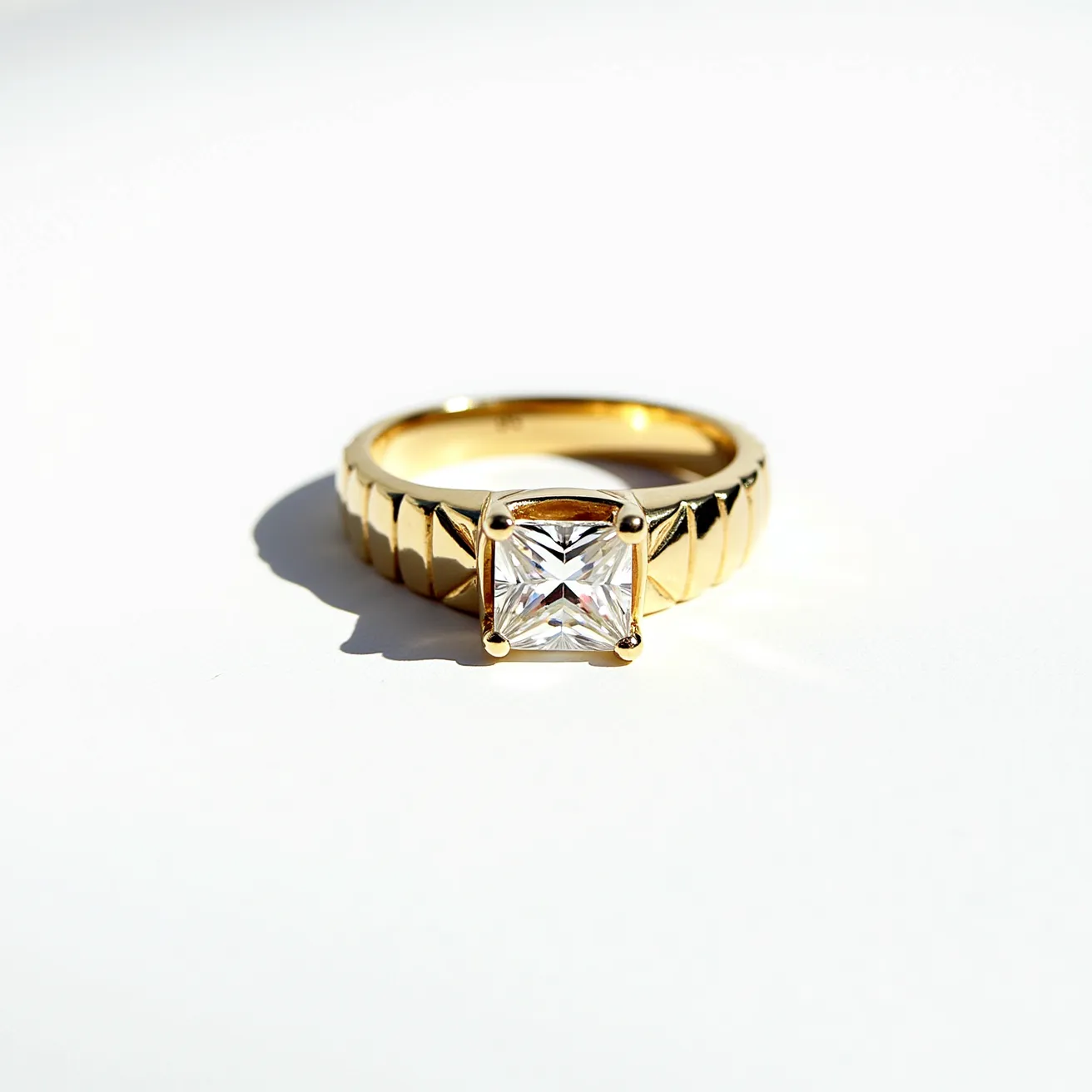 This men's engagement ring features a prominent square-cut gemstone set in a four-prong setting, which securely holds the stone in place, showcasing its brilliance. The band is crafted from a gold material, exhibiting a robust and polished finish. The band displays a distinctive design with angular or geometric patterns, adding a modern and stylish touch to the ring. The ring's elegant yet bold design combines traditional elements with contemporary aesthetics, making it a striking piece of jewelry.