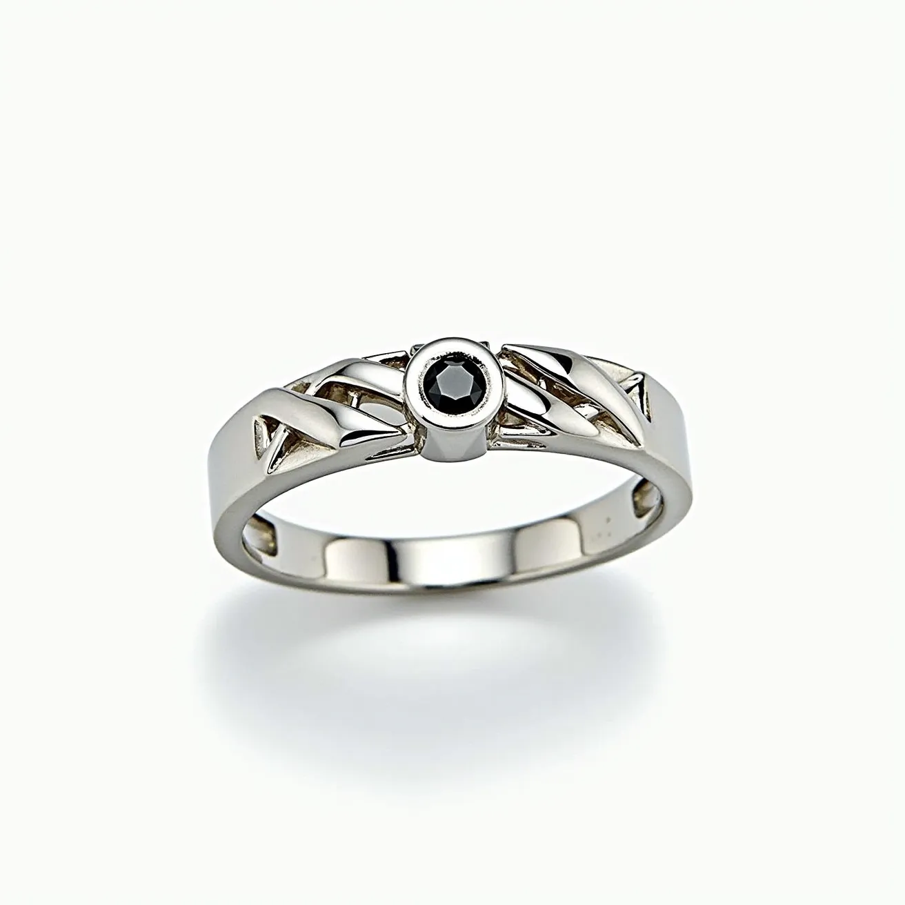 This men's engagement ring features a sleek and modern design crafted from a polished metal that appears to be white gold or platinum. At its center, the ring showcases a black diamond, cut into a round shape, which is set securely in a bezel setting. The sides of the band incorporate a pattern with openwork detailing, adding a unique and decorative element to the overall design. The craftsmanship highlights both simplicity and elegance, ideal for a distinctive and stylish engagement symbol.