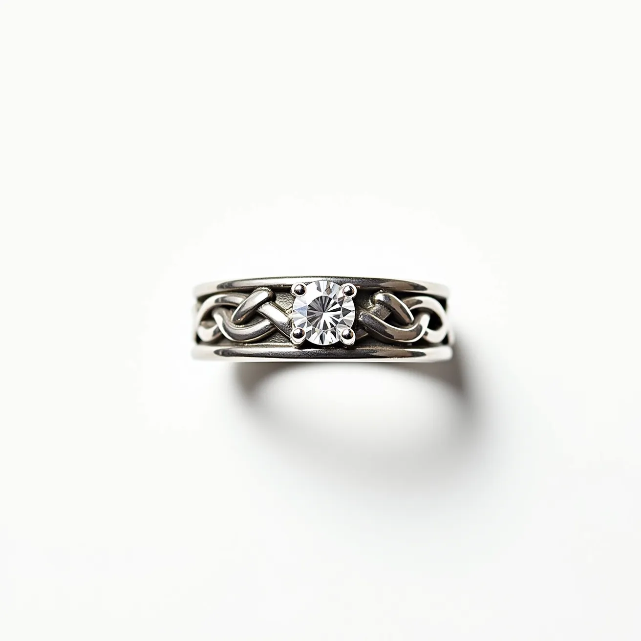 This men's engagement ring features a bold design crafted from a silver-toned metal, providing a durable and sleek appearance. At the center, the ring showcases a single round-cut diamond securely set in a classic four-prong setting, allowing the stone to take center stage and sparkle brilliantly. The band incorporates an intricate knot design, adding a touch of elegance and artistry. The ring does not include additional clasps or attachments, emphasizing the simplicity and sophistication of its design.