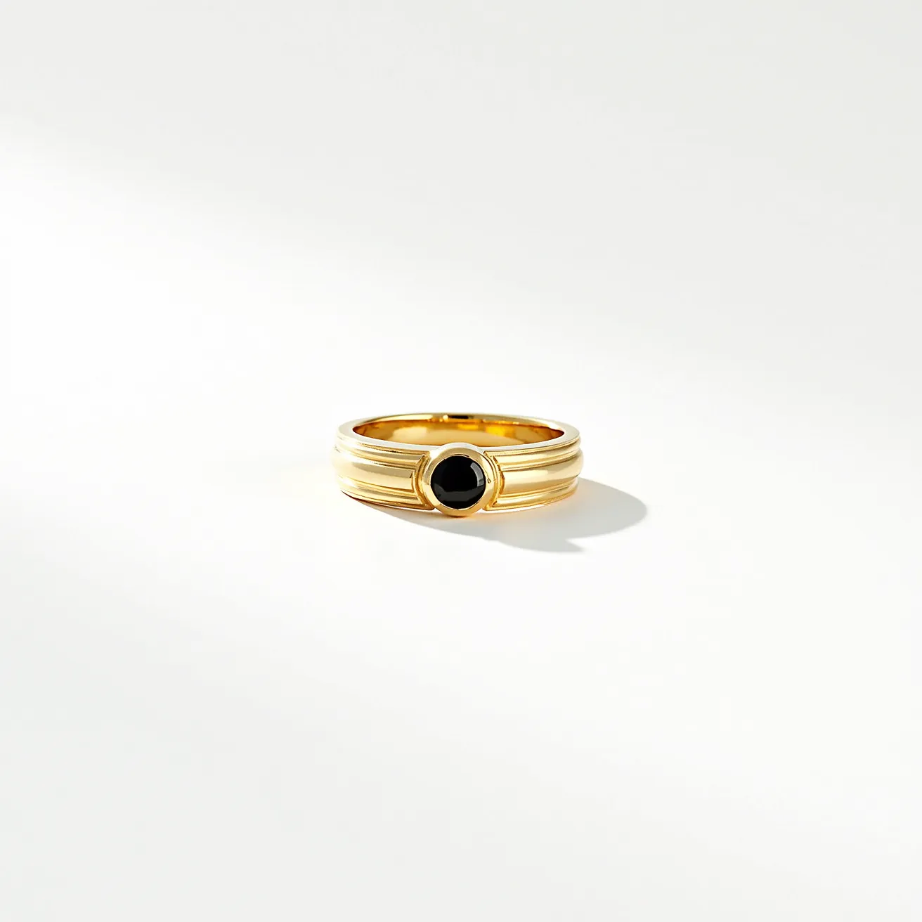 This men's pinky ring features a sleek design crafted from what appears to be a polished yellow metal, likely gold. Central to the ring is a round, black gemstone, possibly onyx, set smoothly within a bezel setting. The stone's surface is polished, enhancing its deep, dark hue, and providing a striking contrast to the glossy metal band. The band is adorned with subtle, horizontal lines that add texture and interest to the overall appearance. There is no visible clasp or attachment, indicating a traditional ring style.