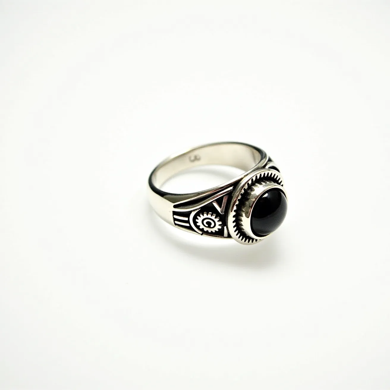 This men's silver ring features an elegant design with a striking black onyx gem set at its center. The onyx is polished into a smooth, rounded cabochon cut, which is held securely in place by a serrated bezel setting, adding a touch of sophistication. The silver band is accented with intricate engravings that create a bold, geometric pattern on either side of the stone, enhancing its visual appeal. The ring does not have any clasps or attachments, emphasizing its sleek and continuous design.