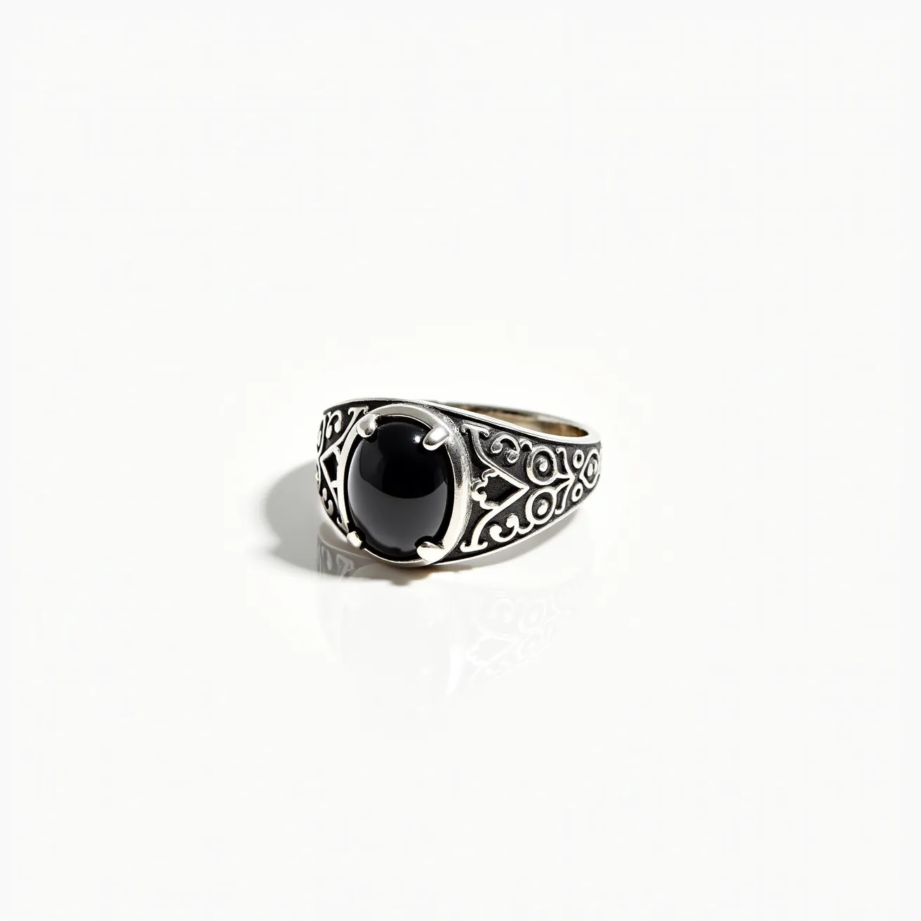 This men's silver ring features an intricately designed band with ornate patterns, suggesting a detailed craftsmanship typical of vintage or antique styles. At its center is a cabochon-cut black stone, securely held in place by a four-prong setting. The smooth surface of the stone contrasts beautifully with the textured design of the band, adding a touch of elegance to the bold appearance of the ring. There is no additional clasp or attachment, making it a straightforward yet striking piece of jewelry.