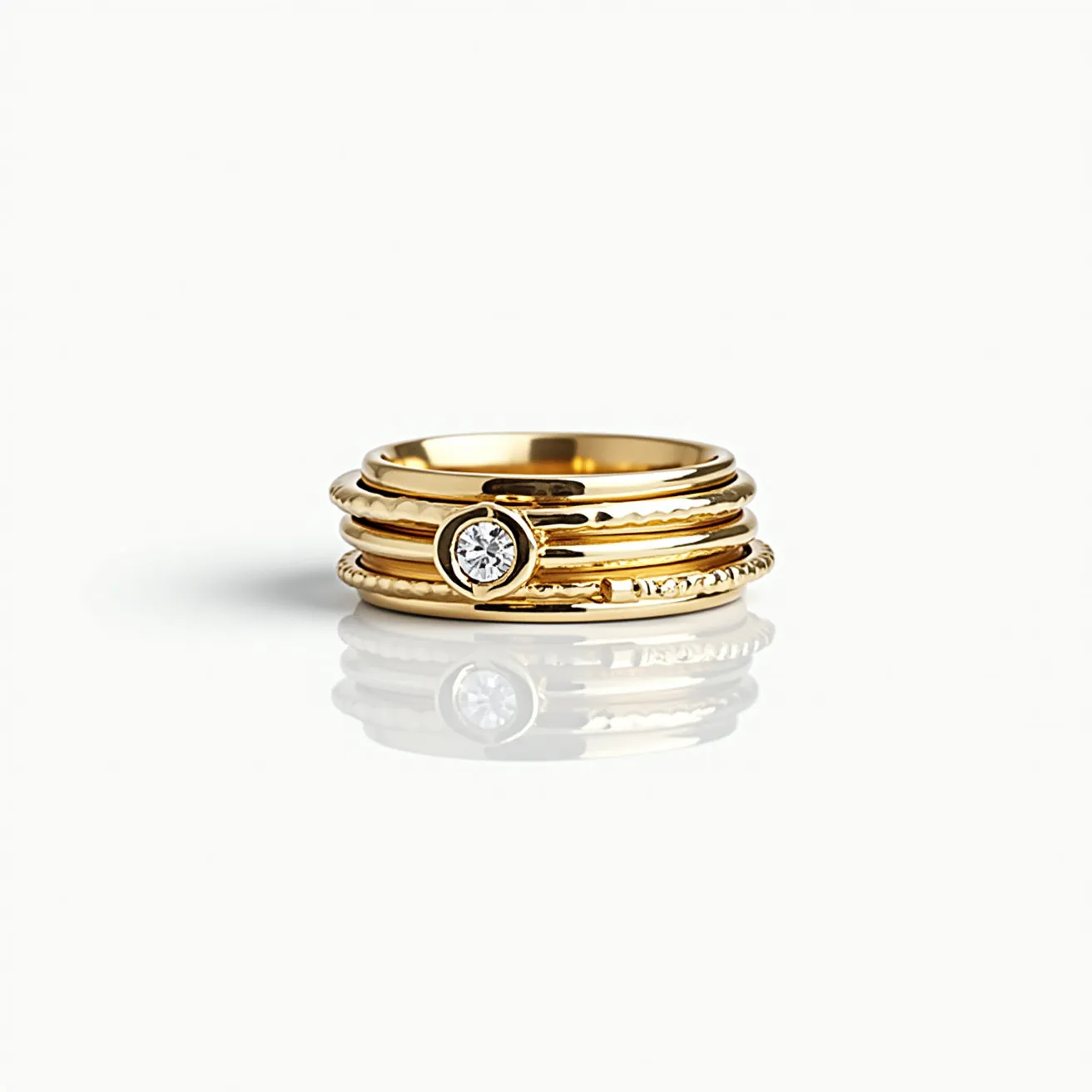 This men's spinner ring is crafted from gold and features a central bezel setting that securely holds a round-cut clear gemstone. The design includes multiple bands, each with a distinct texture, offering an intricate and stylish look. The central stone adds an elegant accent, while the overall design allows for movement, typical of spinner rings. The absence of a visible clasp suggests a continuous band that enhances the seamless appearance of the ring.