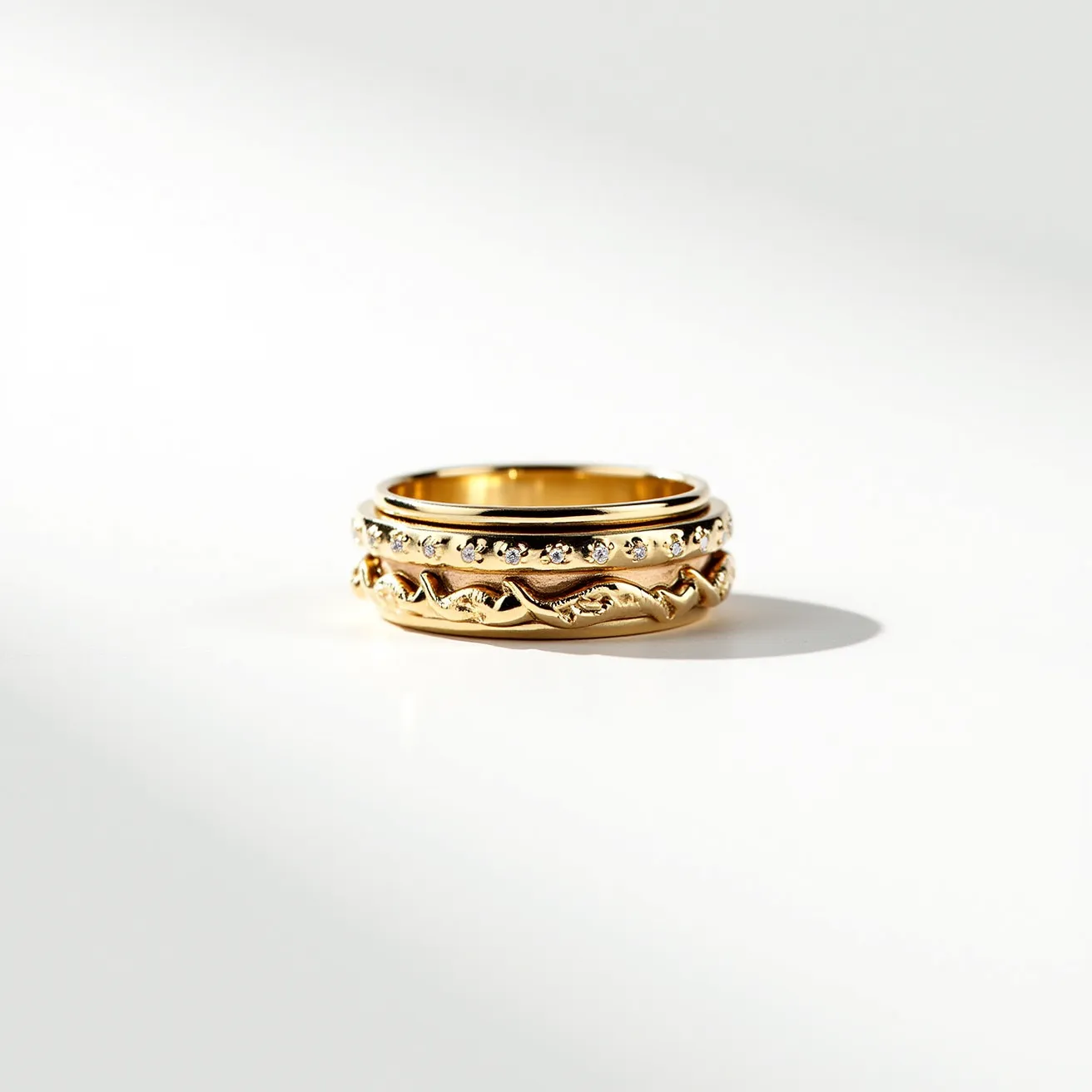 This men's spinner ring features a central band made from polished gold with an intricate design of woven patterns. The upper section of the ring is adorned with a series of small, round brilliant-cut stones, possibly diamonds, set in a channel setting that allows them to align closely and catch light from various angles. The outer band, which spins around the inner band, adds a dynamic element to the design. The spinner mechanism operates smoothly without the need for visible clasps or attachments, providing both aesthetic appeal and functional enjoyment.