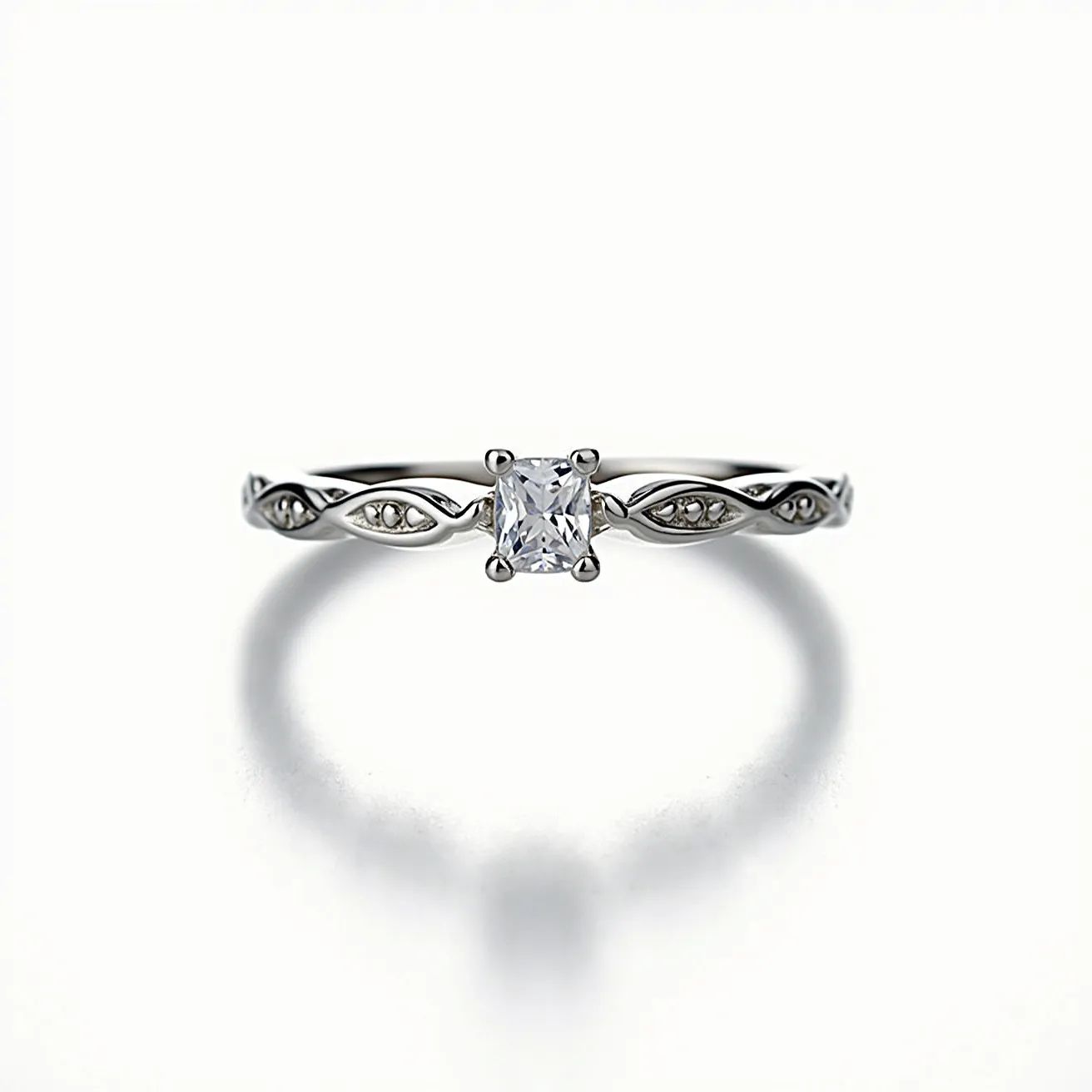 This moissanite promise ring features a central square-shaped moissanite stone, set in a four-prong setting. The band is crafted from a shiny, silvery metal and is adorned with intricate detailing on either side of the central gem. The band includes small, embedded stones or metalwork, adding an elegant touch that complements the main stone. The delicate, flowing design of the band enhances the overall sophistication of the piece, making it a beautiful symbol of commitment.