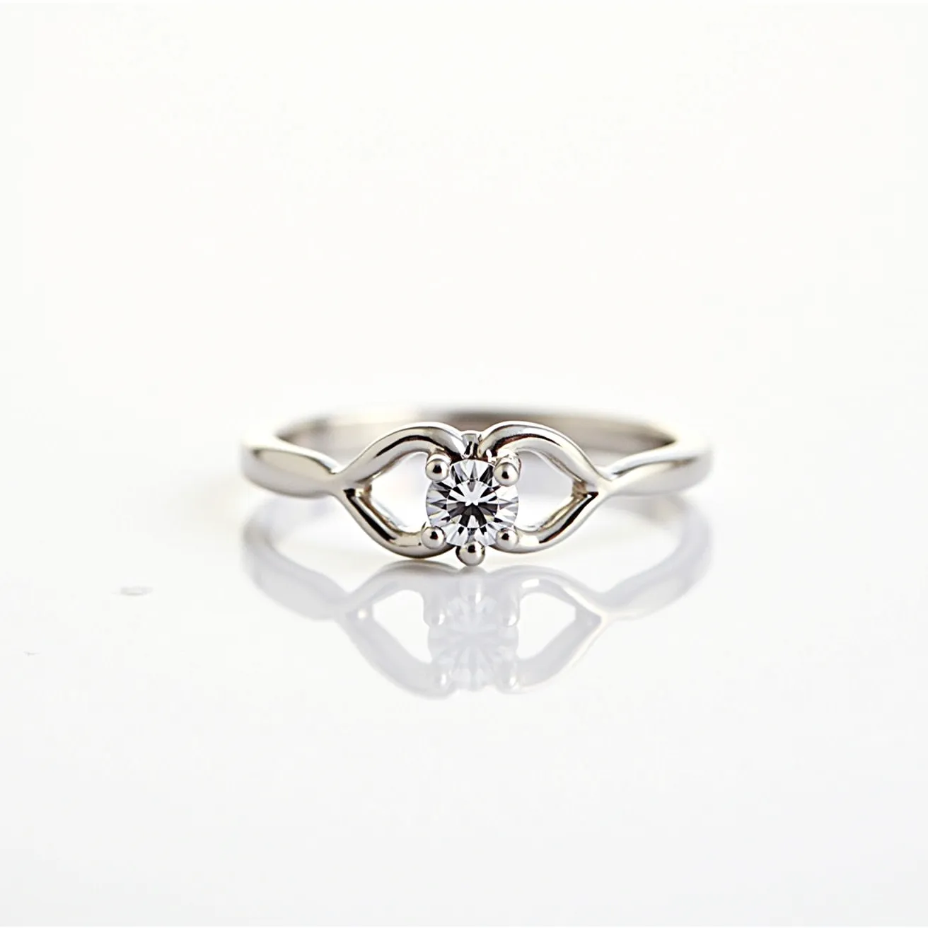 This moissanite promise ring features a central round-cut moissanite stone, which is elegantly set in a prong setting that allows maximum light reflection to enhance its brilliance. The band, crafted from a lustrous metal that appears to be white gold or platinum, exhibits a graceful, interwoven design, adding a touch of uniqueness and sophistication. The design suggests a delicate balance of modern elegance and traditional craftsmanship, with an emphasis on highlighting the central gemstone. This arrangement is securely attached to the band, offering both aesthetic appeal and durability.