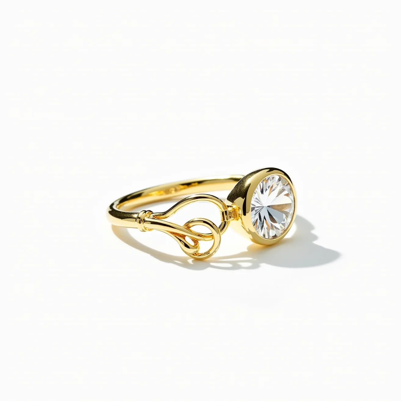 This moissanite ring features a prominent round-cut moissanite gemstone set in a bezel setting. The band is crafted from what appears to be a yellow gold, which complements the brilliance of the moissanite. The design includes an elegant looped detail on the band, adding a touch of sophistication and artistry. This intricate feature enhances the visual appeal and balances the minimalist aesthetic with a touch of elegance.