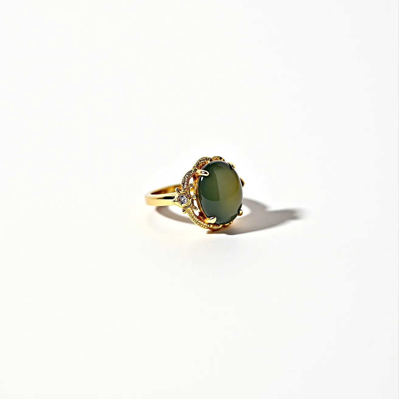 This moss agate ring features a smooth, polished cabochon cut moss agate stone as its centerpiece, showcasing the stone's natural, earthy inclusions reminiscent of moss. The stone is secured in a prong setting, which holds it tightly on a gold band. The design includes intricate metalwork around the base of the stone, adding a touch of elegance to the overall aesthetic. The gold band is likely crafted from either gold or a gold-colored alloy, contributing to its classic, timeless appeal. The ring is a beautifully crafted piece that highlights the unique characteristics of moss agate through a sophisticated setting.