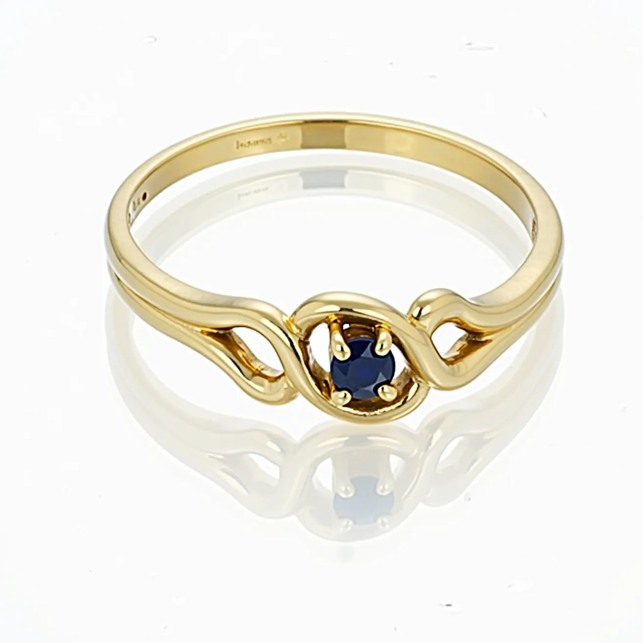 This mothers ring is elegantly crafted from yellow gold, featuring a beautifully set round blue sapphire at its center. The sapphire is held securely in place by a four-prong setting, allowing it to be prominently displayed. The band's design incorporates smooth, flowing lines that gently cradle the stone, adding a touch of sophistication to the overall aesthetic. The gold's warm tone complements the deep blue of the sapphire, making this piece both stylish and sentimental.