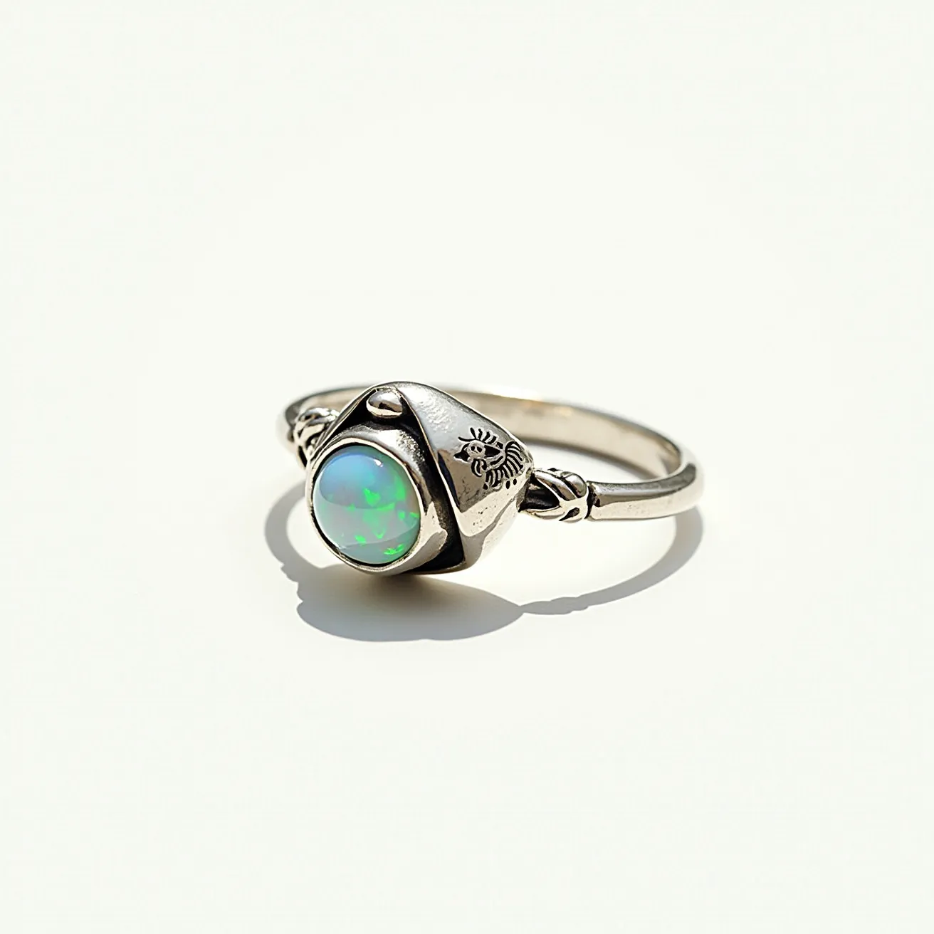 This mushroom ring features a beautifully crafted setting in metal that artistically resembles a mushroom. At its center, the ring showcases a round opal stone, with vibrant hues of green and blue that catch the light. The opal is held securely in a bezel setting, which enhances its iridescent colors. The band is adorned with intricate designs, adding a touch of artistry and enhancing the overall aesthetic appeal. The ring's combination of natural motifs and gemstones makes it a charming and unique piece of jewelry.