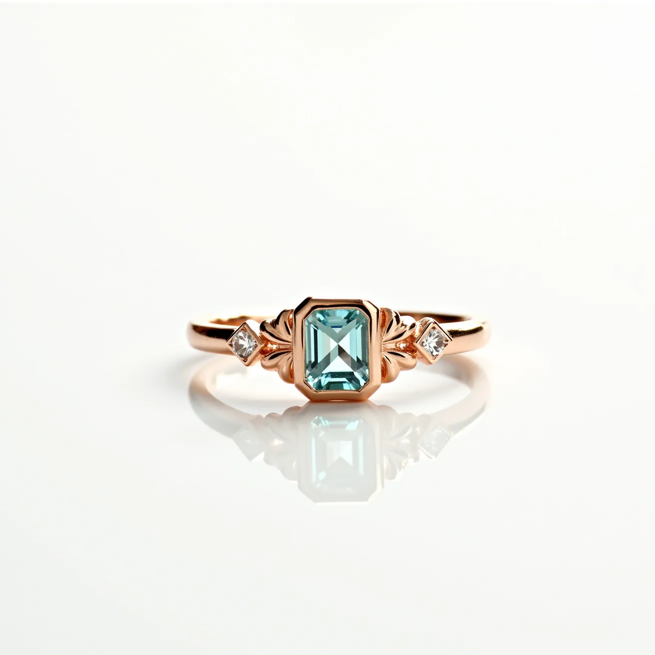 This November birthstone ring features a sophisticated design centered around a blue topaz gemstone, cut in an emerald shape, which is typical for November. The topaz is set in a rose gold band, emphasizing its warm hues and elegant style. This central gemstone is flanked on either side by smaller, square-cut diamonds that add a touch of sparkle and symmetry to the ring. The band's intricate detailing, which includes leaf-like motifs, complements the stones and enhances the overall aesthetic.