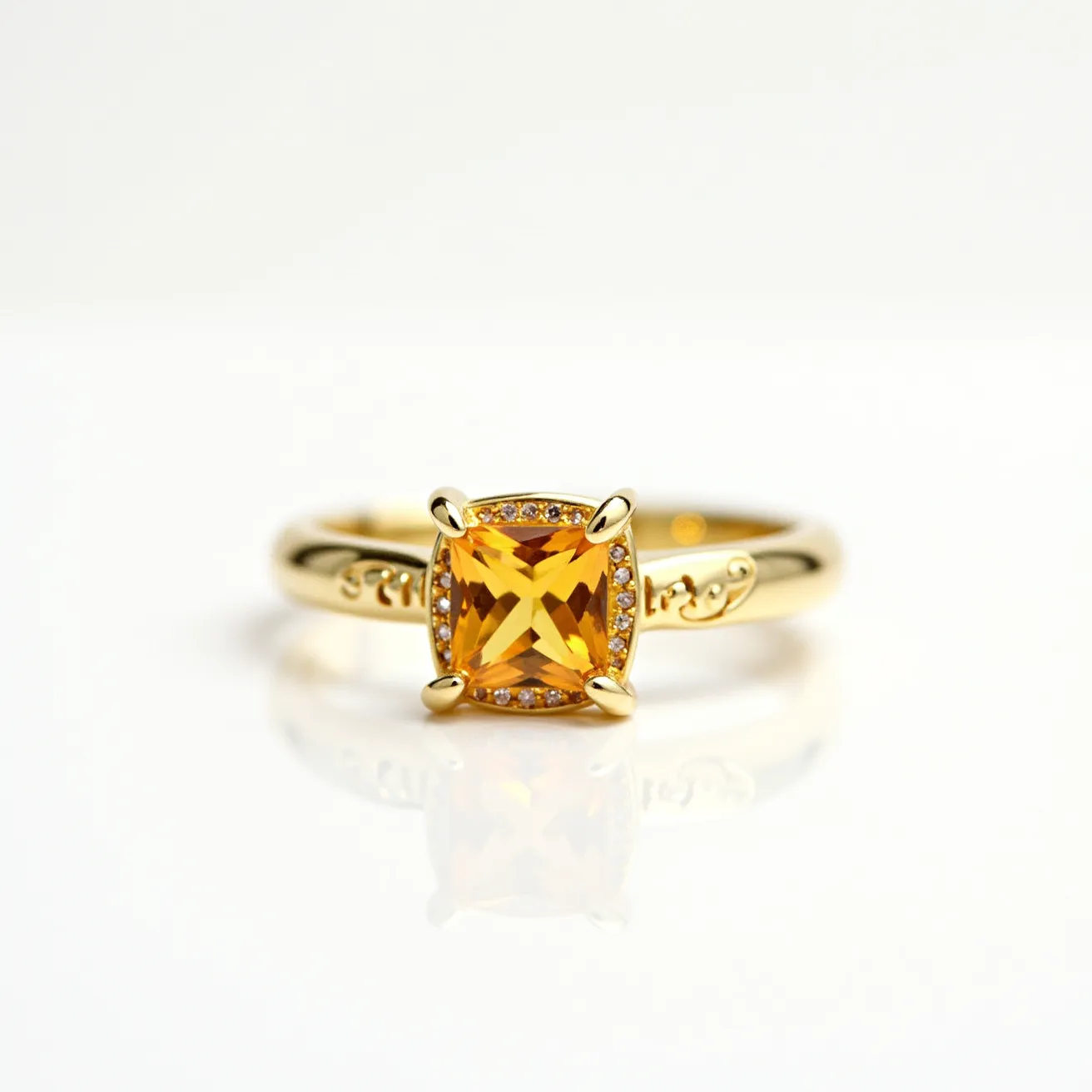 This November birthstone ring features a striking square-cut citrine gemstone, set prominently in a four-prong setting that showcases its warm golden hues. Encircling the citrine is a delicate halo of smaller accent stones, adding a touch of elegance and sparkle. The band is crafted from polished gold, and it displays intricate detailing along the shank, complementing the centerpiece beautifully. The classic design emphasizes both the brilliance of the citrine and the quality of the craftsmanship.