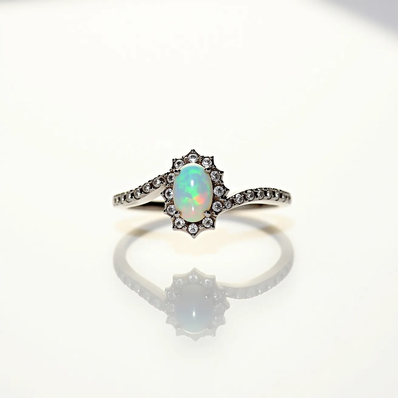 This opal engagement ring features a striking oval-shaped opal as the central gemstone, showcasing its characteristic play of colors. Surrounding the opal is a halo of small, round-cut diamonds set in a prong setting, enhancing the ring's brilliance. The band itself is crafted from a polished metal, likely white gold or platinum, and is adorned with additional round-cut diamonds that continue halfway down the shank, providing a cohesive and elegant look. The ring's design seamlessly integrates the gemstones and metalwork, offering a classic yet unique aesthetic.