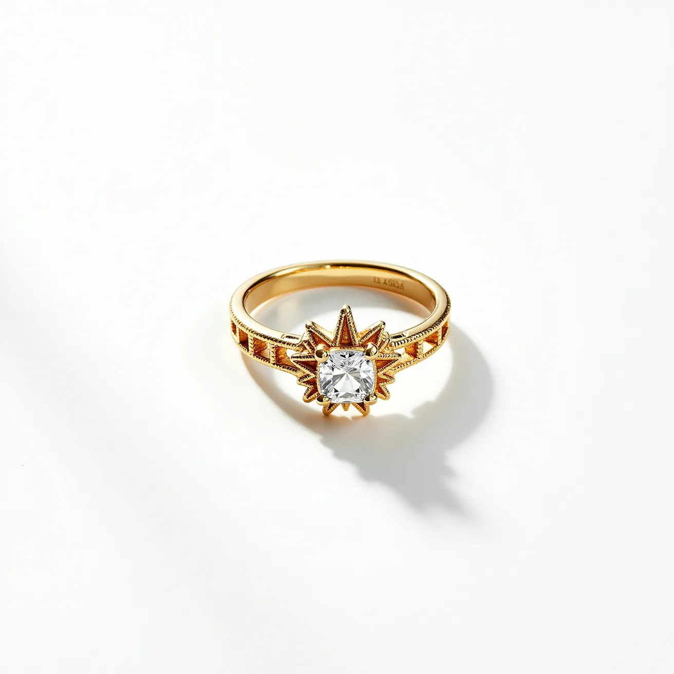 This open ring features a gold band adorned with intricate engravings, adding to its elegant appearance. At the center, a square-cut gemstone, likely a diamond, is meticulously set in a prong setting within a star-shaped motif. The gem is elevated, allowing light to enhance its brilliance. The design integrates both classic and modern elements, creating a unique piece of jewelry. The band's uniform texture and detailed craftsmanship highlight the ring's quality and artistry.