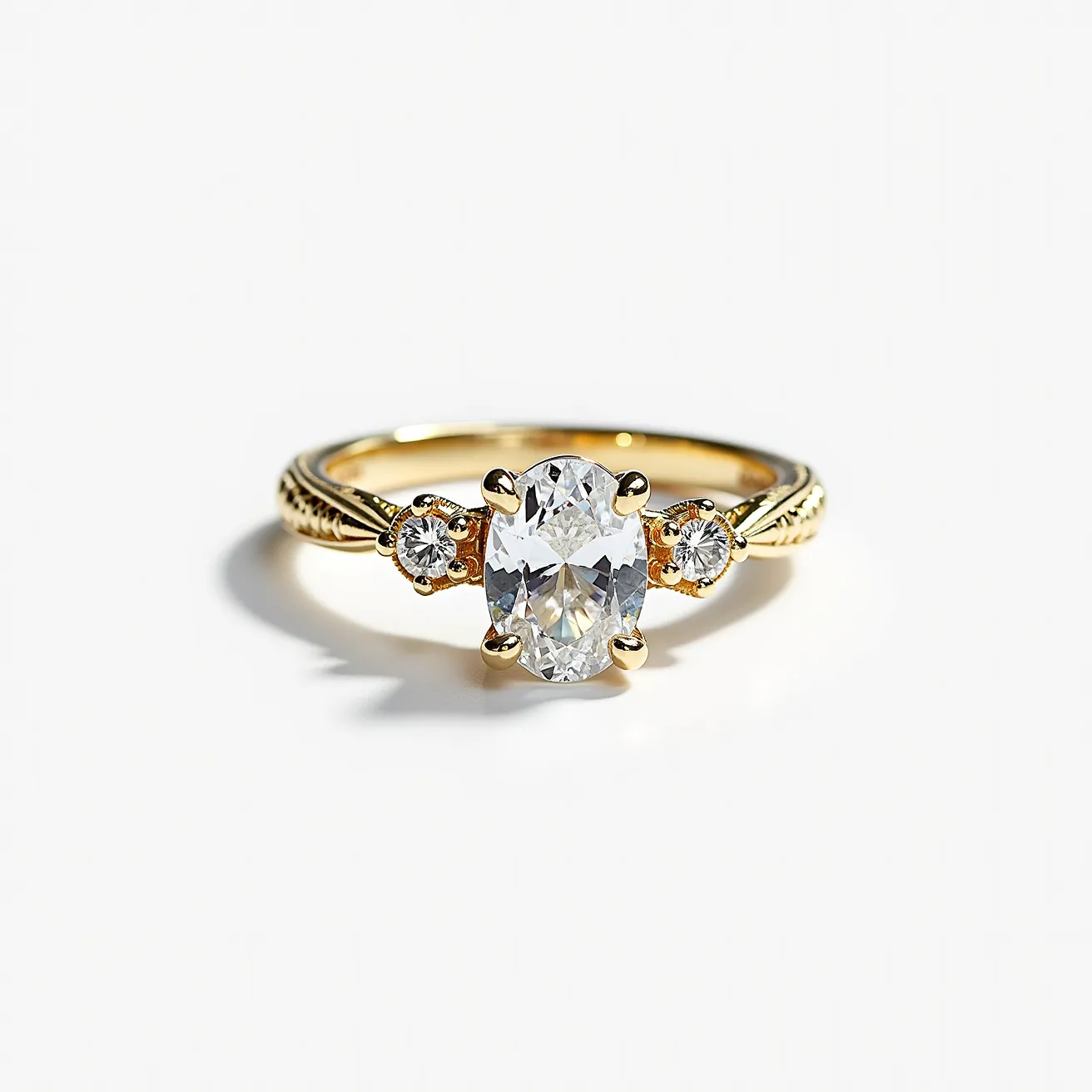 This oval engagement ring features a captivating central oval-cut diamond, elegantly set in a four-prong setting to highlight its brilliance. The band, crafted from a luxurious yellow gold, is intricately designed, adding a touch of vintage charm. Flanking the main stone are two smaller round-cut diamonds, each equally secured in prong settings, enhancing the overall sparkle and sophistication of the piece. The prong settings securely clasp the stones, ensuring both beauty and durability, making this ring a timeless symbol of elegance and commitment.