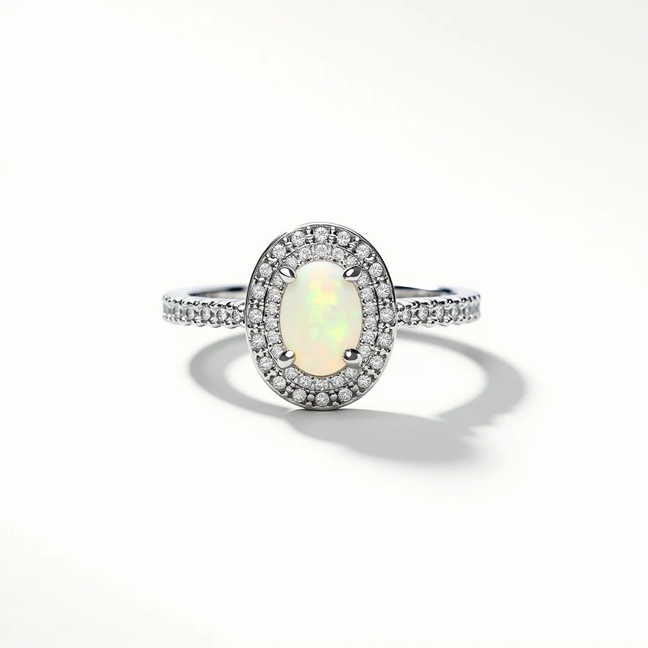 This oval engagement ring features a central opal gemstone, expertly cut into an oval shape, which exhibits a captivating play of colors. The opal is securely held by four prongs, each gleaming in harmony with the centerpiece. Surrounding the opal is a halo of small, round-cut diamonds, enhancing the ring's overall sparkle and elegance. The band is made from a polished metal, likely white gold or platinum, and is adorned with additional small diamonds, adding to the luxurious feel of the piece. Together, these elements create a sophisticated and eye-catching design.