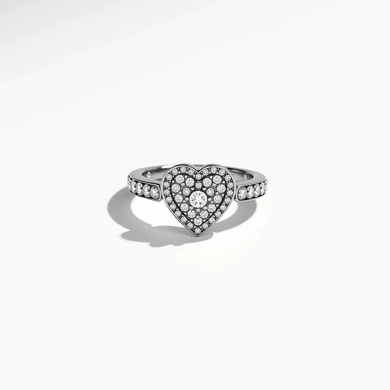 This pave diamond ring features a heart-shaped design encrusted with numerous small, round-cut diamonds meticulously set in a pave setting, creating a continuous sparkling surface. The central diamond stands out, surrounded by a symmetrical arrangement of smaller diamonds that enhance its brilliance. The band itself is crafted from a lustrous metal, possibly white gold or platinum, adorned with additional diamonds in a linear pattern that seamlessly complements the heart motif. The overall design exudes elegance and sophistication, making it a captivating piece of jewelry.