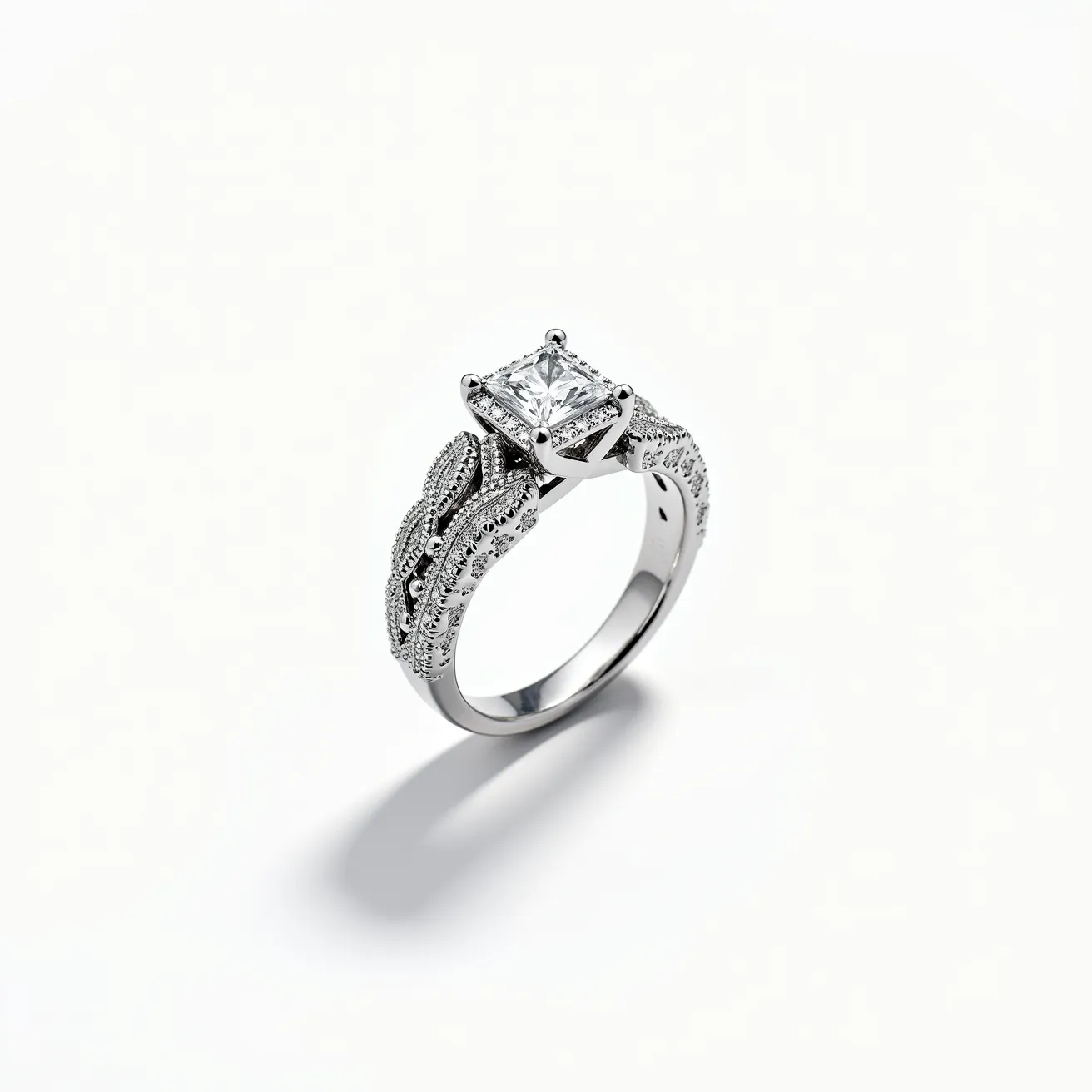 This pave diamond ring features a central, prominent square-cut diamond set in a secure prong setting, which draws attention to the elegance of its design. The band of the ring is crafted from a silver-toned metal, likely white gold or platinum, enhancing the overall brilliance. The band is intricately detailed with a pave setting of smaller round diamonds, adding texture and additional sparkle to the piece. The combination of the central diamond and the pave setting on the band creates a luxurious and striking appearance, making this ring a standout piece of jewelry.