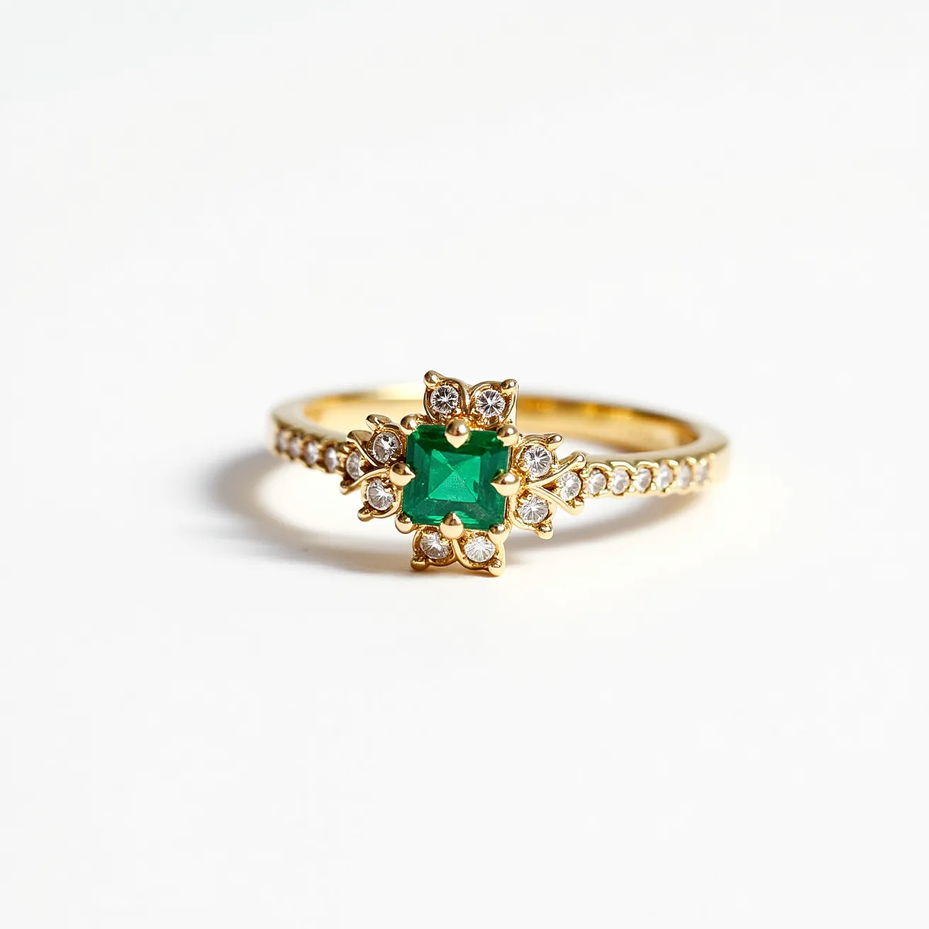 This pave diamond ring features a brilliant centerpiece with a striking emerald-cut green gemstone set amidst a radiant cluster of smaller round diamonds. The primary gem is securely held by a prong setting, creating a captivating focal point. Surrounding the main stone, the band is embellished with numerous small round diamonds set closely together in a pave style, enhancing the ring's overall sparkle and elegance. Crafted in what appears to be yellow gold, the band complements the vividness of the green gem, while also providing a luxurious backdrop for the diamonds. The combination of materials and stones gives the ring a classic yet sophisticated appearance, suitable for a variety of occasions.