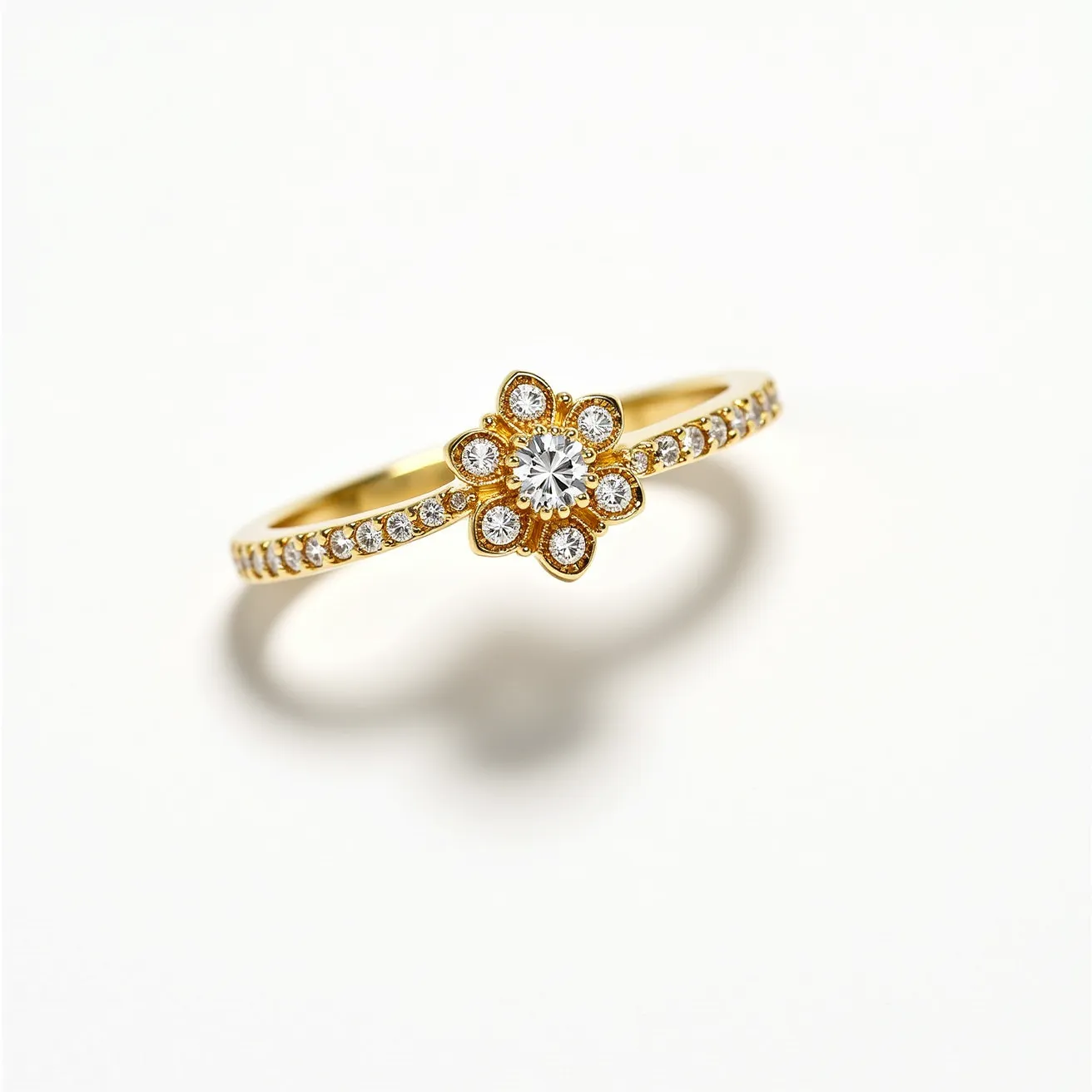 This pave ring is crafted from a polished gold band, adorned with a series of small, round-cut diamonds intricately set along its shank. The centerpiece features a floral design with a central, larger round-cut diamond encircled by a petal-like arrangement of smaller diamonds, all secured in a pavé setting. The elegant design emphasizes symmetry and brilliance, offering a delicate yet striking appearance. The diamonds are securely embedded into the metal, enhancing the ring’s sparkle without the addition of any clasps or other attachments.