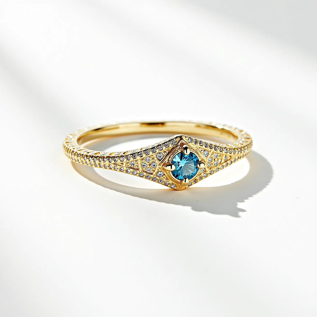 This pave ring features a band crafted from polished gold, adorned with a multitude of small, round-cut diamonds set in a pave style, creating a continuous sparkle along the band. At its center, a larger round-cut blue gemstone, likely a sapphire or topaz, is securely held in place by a four-prong setting that highlights its brilliant facets. The combination of the shimmering diamonds and the striking central stone gives the ring an elegant and sophisticated appearance.