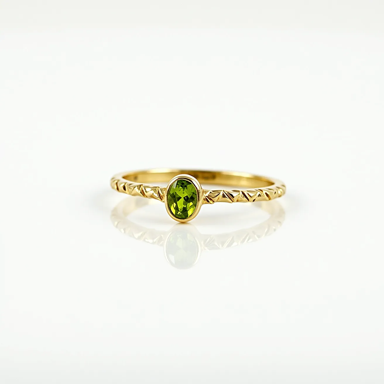 This peridot engagement ring features a beautiful oval-cut peridot gemstone set in a bezel setting, showcasing its vibrant green hue. The band is crafted from a gold material with a delicate, textured pattern along its surface, enhancing its elegant design. The sleek and secure bezel setting ensures the peridot is held firmly in place, allowing for both practical wear and aesthetic appeal. This ring combines simplicity with sophistication, making it a striking piece for an engagement.