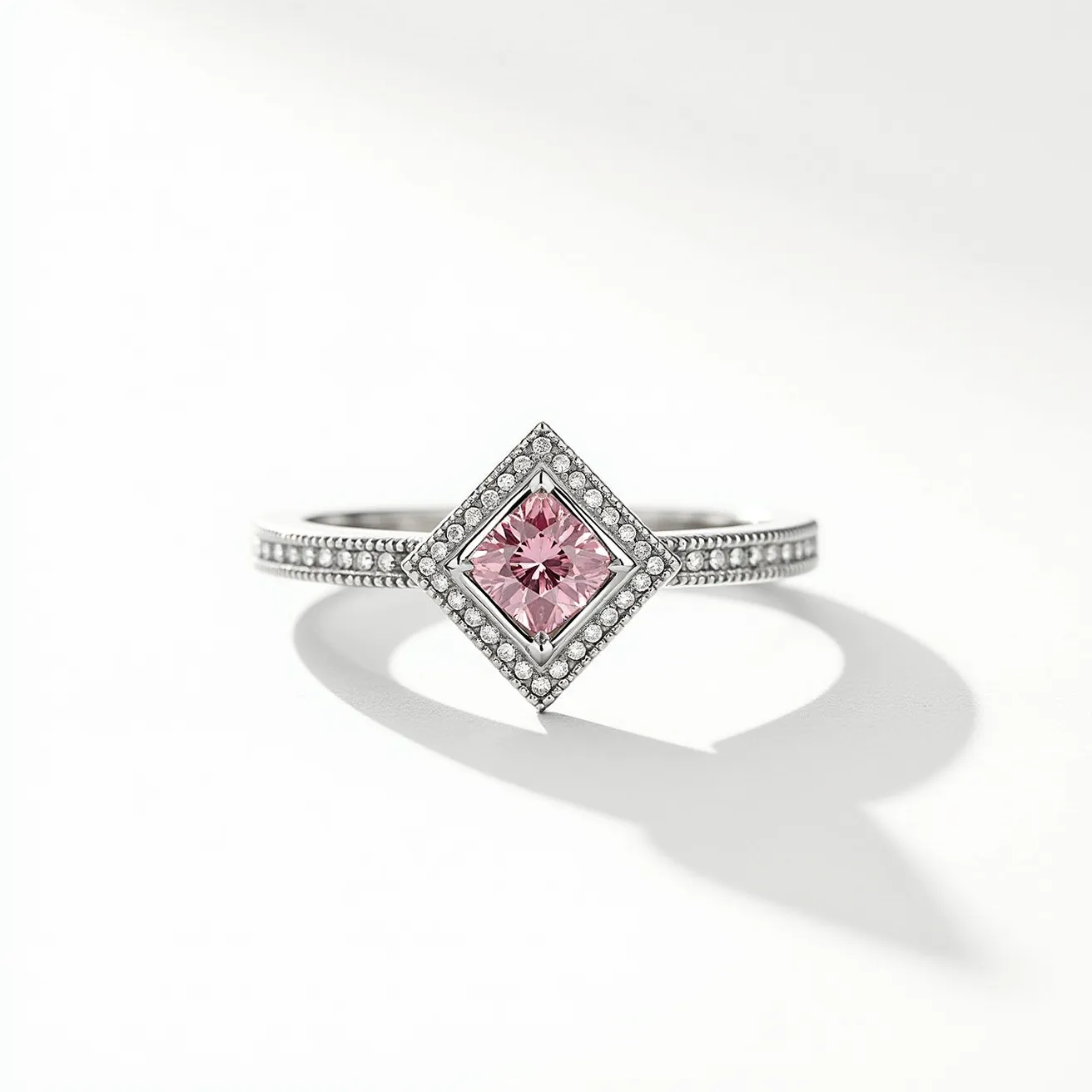 This pink diamond ring features a central square-cut pink diamond that is framed beautifully within a delicate halo of smaller white diamonds, enhancing its color and brilliance. The setting is likely made of white gold or platinum, providing a lustrous and durable foundation that complements the diamonds. The band itself is intricately designed with an array of small round diamonds set into the metal, adding additional sparkle and elegance to the overall design. The ring's sophisticated composition showcases a thoughtful alignment of gems and materials, creating a piece that exudes luxury and grace.