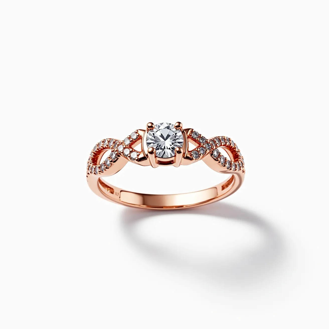 This pink diamond ring features a rose gold band intricately designed with an elegant infinity pattern adorned with small round-cut diamonds. The centerpiece is a round-cut diamond, secured in a four-prong setting, which adds a classic and timeless appeal to the piece. The combination of the pinkish hue of the metal and the sparkle of the diamonds creates a harmonious and luxurious look. The ring does not have any visible clasps or additional attachments, allowing the design and craftsmanship to be the focal point.