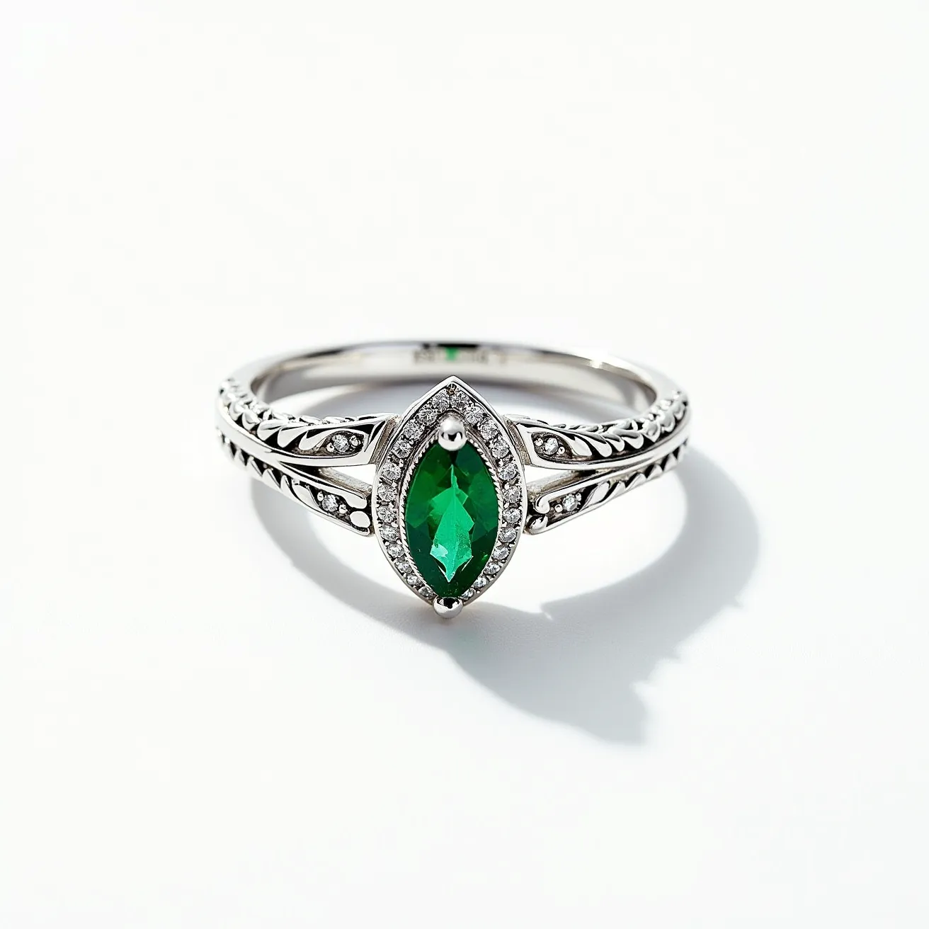 This prasiolite ring features a beautifully cut marquise prasiolite gemstone, which is set prominently as the centerpiece. The stone is surrounded by a halo of small, round-cut diamonds, enhancing its vibrant green hue. The band is intricately designed with a leaf-like motif, adding an elegant touch, and is made of polished silver metal, giving it a sleek and sophisticated appearance. The split shank design complements the setting, creating a balanced and refined look. The ring's craftsmanship and thoughtful arrangement of gems highlight its delicate beauty and timeless appeal.