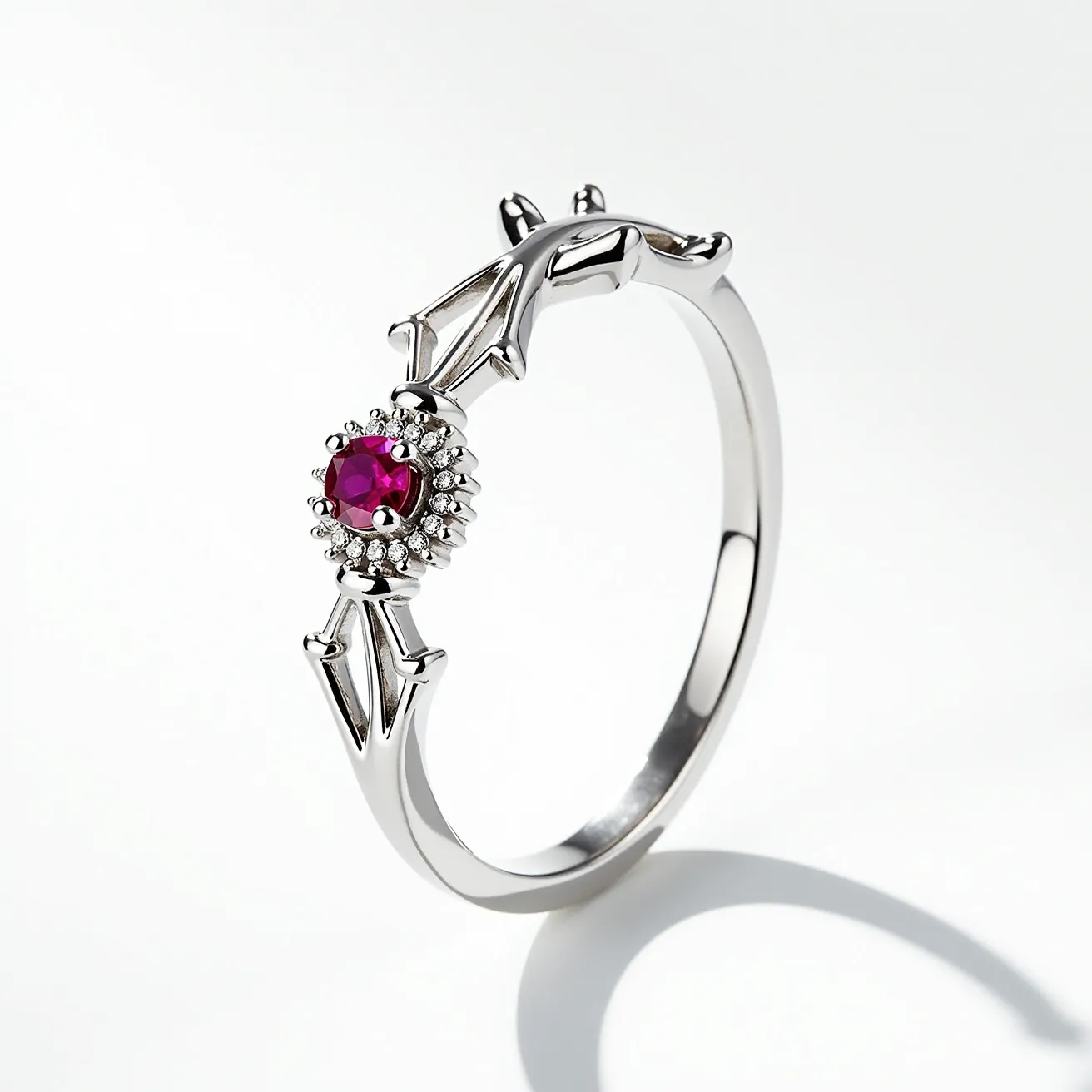 This promise ring features a delicate design crafted from a shiny, metallic material, likely silver or white gold. The centerpiece is a round-cut ruby set in a halo setting, surrounded by a row of small, sparkling diamonds, enhancing its vibrant red hue. The band is elegantly detailed with intricate, vine-like patterns, adding a touch of nature-inspired artistry. The overall craftsmanship showcases a blend of elegance and uniqueness, perfect for symbolizing a meaningful promise.