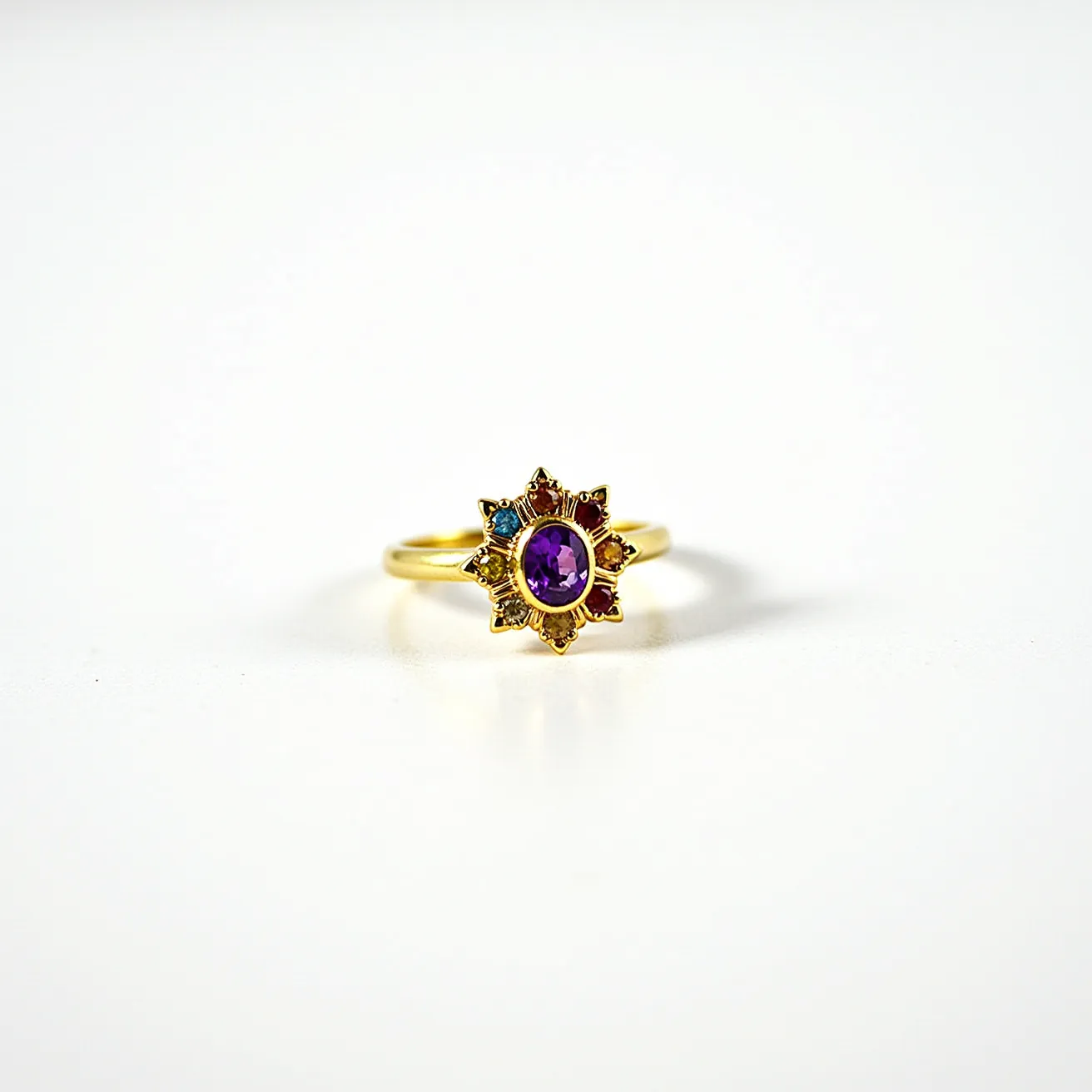 This rainbow ring features a central purple gem, likely an amethyst, cut in an oval shape. The stone is securely set within a bezel setting, ensuring durability and a sleek appearance. Surrounding the center gem are smaller colorful stones arranged in a starburst pattern, creating a captivating rainbow effect that enhances the central gem's vibrancy. The band of the ring appears to be crafted from gold, offering a warm and luxurious contrast to the cool tones of the stones. The design does not include any visible clasps or attachments, indicating a seamless and classic band structure.