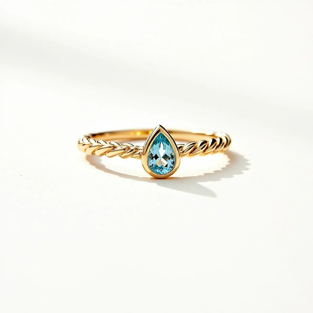 This Rapunzel promise ring features a beautifully braided band crafted from gold, providing an elegant and timeless appeal. At its center, a stunning teardrop-shaped blue gemstone is set in a simple, bezel setting, which securely holds the gem while accentuating its vibrant hue. The intricate design and craftsmanship embody a sense of romantic charm, making it a meaningful token of commitment. The ring's design is both delicate and striking, capturing the essence of a fairytale promise.