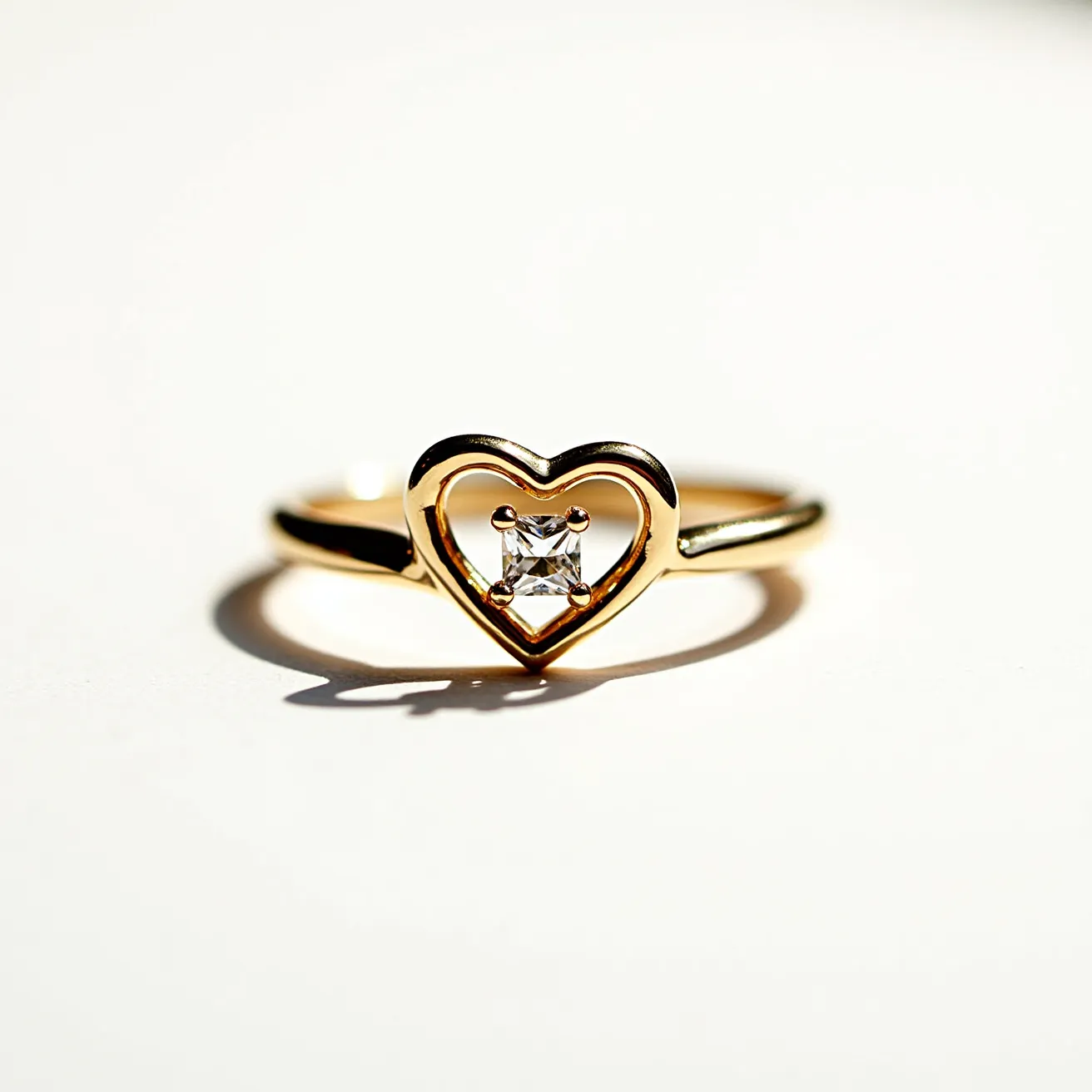 This Rapunzel ring is crafted from gold and features a delicate heart-shaped design at its center. A single, square-cut gemstone is elegantly positioned in a secure prong setting within the heart, adding a touch of sparkle and sophistication. The ring's band is slender and graceful, seamlessly enhancing the overall elegant appearance. The combination of the gold material and the central gemstone creates a timeless and enchanting piece.