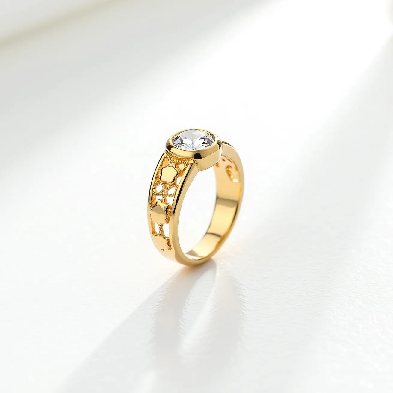 This ring band is crafted from a gold-toned metal featuring a decorative pattern with cut-out star shapes along the band. The band showcases a central round, faceted clear gemstone set in a bezel setting, which securely holds the stone in place. There is no visible clasp or additional attachment, focusing the design on the continuous loop of the band itself. The combination of the gemstone and intricate detailing contributes to its elegant and sophisticated appearance.