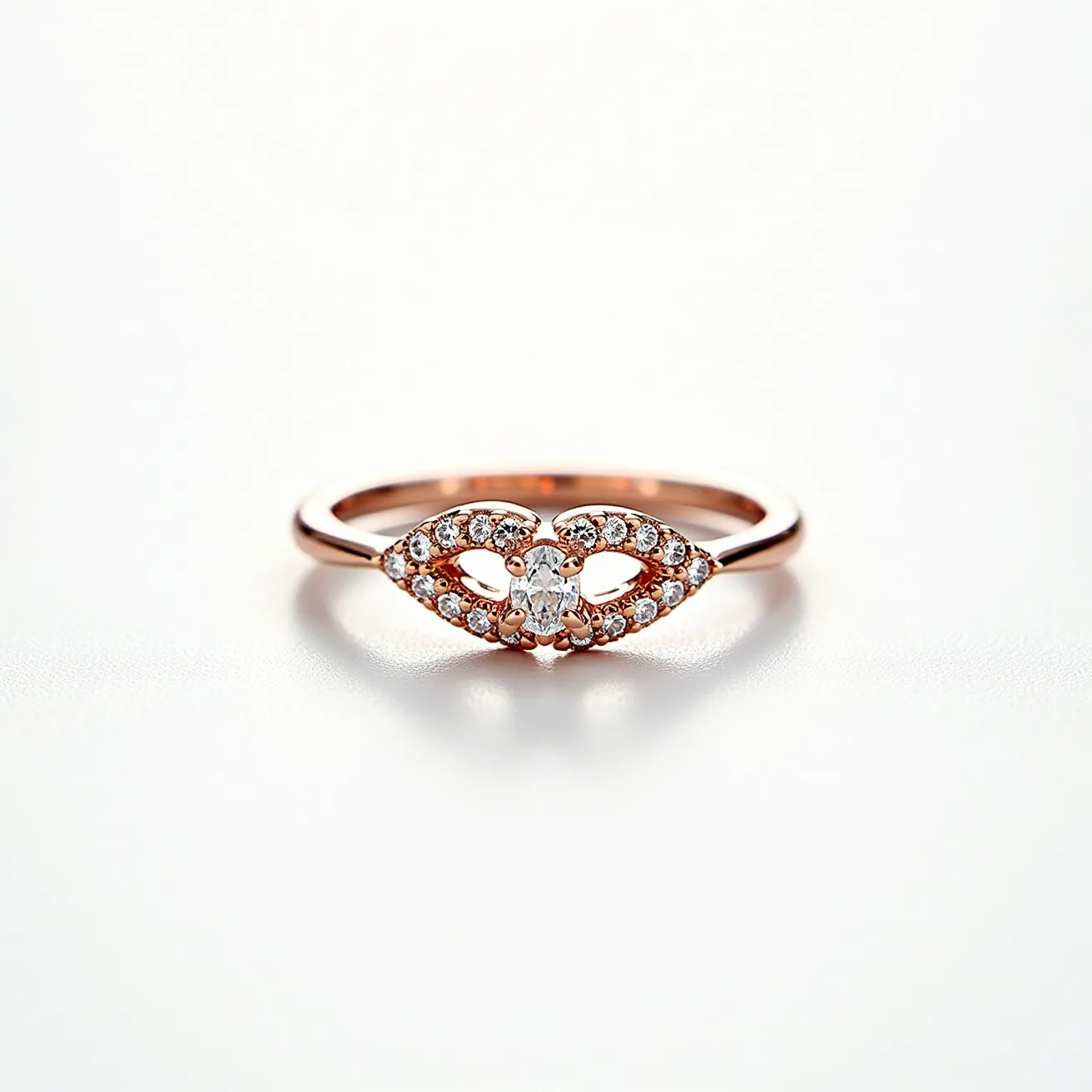 This rose gold ring features a finely crafted band adorned with a series of small, round diamonds. The stones are set within an intricate design at the center of the ring, forming an elegant openwork motif that resembles interlocking teardrops or an infinity symbol. The diamonds are pave-set, which enhances their sparkle and complements the warm hue of the rose gold. The central focus is an oval-cut diamond held in place by four prongs, adding a touch of sophistication to the overall design. There is no visible clasp or additional attachments on the ring, emphasizing its seamless and graceful form.