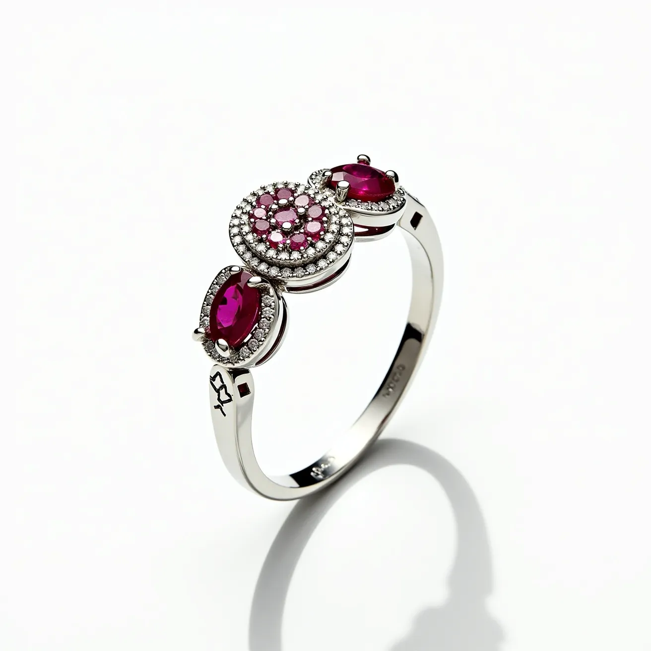 This rose ring features a beautifully crafted arrangement of deep red gemstones set in an elegant band. The ring showcases three main stones—two teardrop-shaped gems flanking a central floral cluster design. The center is composed of smaller round gems creating a rose motif, all surrounded by tiny clear stones in a halo setting, adding a brilliant sparkle. The band appears to be crafted from a polished white metal, likely white gold or platinum, with delicate detailing on the sides. The use of prongs securely holds each gemstone in place, adding both security and style to the piece.