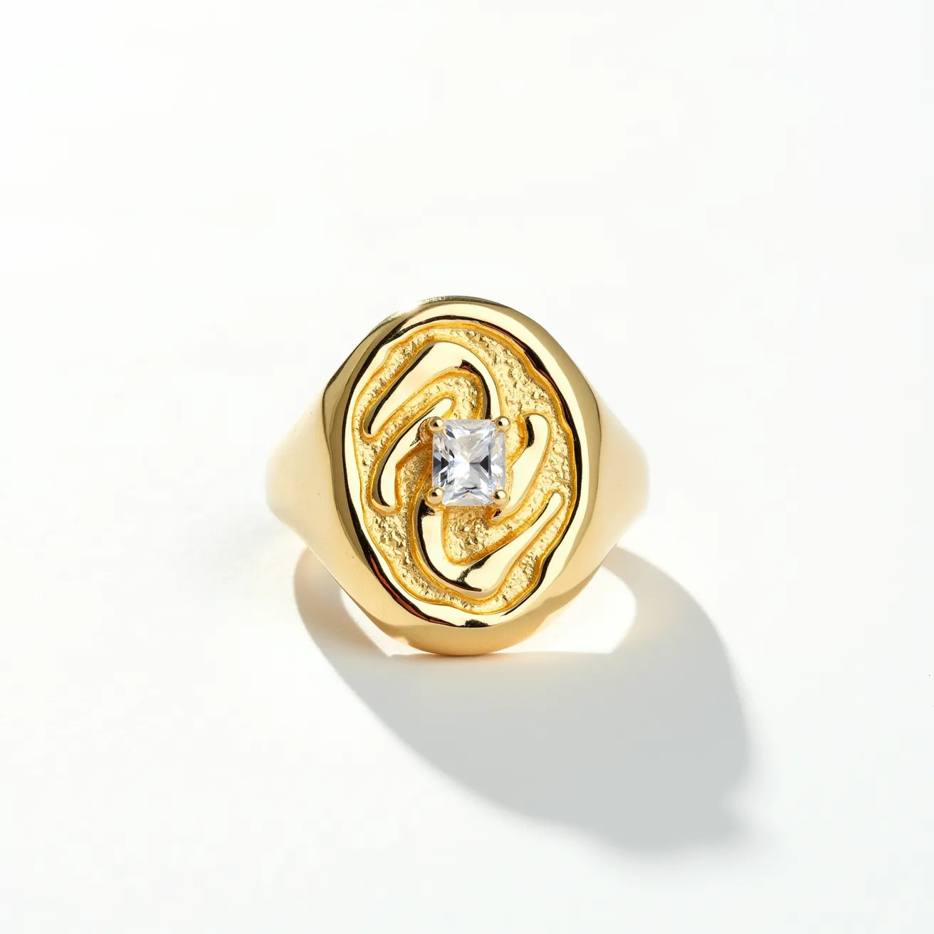 This signet ring features a rich, golden metal as its primary material, showcasing a luxurious and classic design. At its center, the ring boasts a prominent, square-cut clear gemstone, possibly a diamond or a similarly sparkling substitute, securely set in a bezel-style setting. The design includes an intricate, textured pattern surrounding the central stone, adding depth and complexity to the piece. The band is smooth and polished, enhancing the elegance and cohesiveness of the overall design, and it lacks any additional clasps or attachments, indicating it is designed as a traditional slip-on piece.