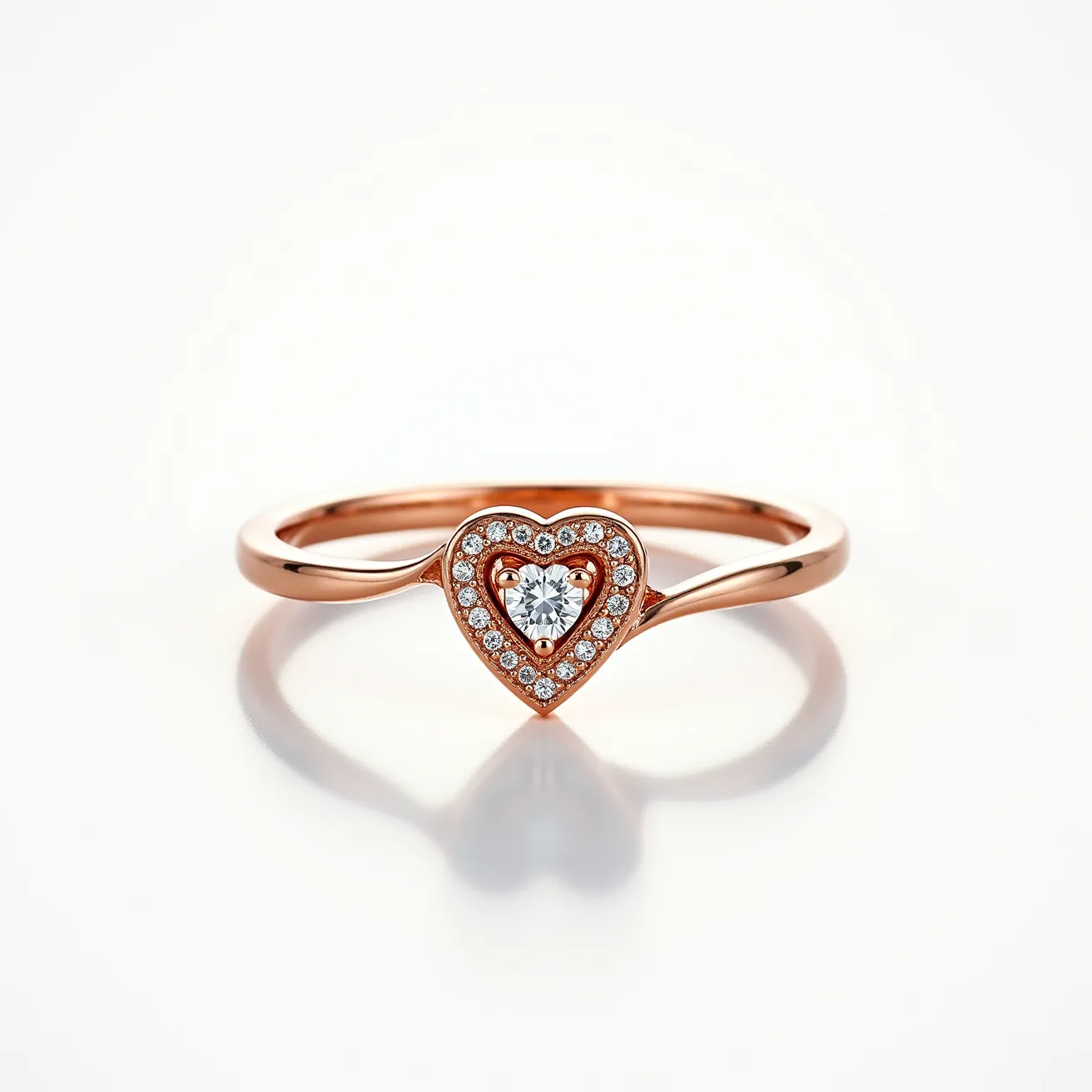 This silver heart ring is skillfully crafted with a rose gold hue, forming a delicate band that holds a heart-shaped centerpiece. The heart is adorned with a central, round-cut gem, likely a diamond, securely set in a prong setting. Surrounding the central gem is an array of smaller round stones, also likely diamonds, which are neatly set into the heart shape, creating a sparkling halo effect. The combination of the rose-colored metal with the shimmering stones enhances the ring's elegance and charm, suitable for a variety of occasions.